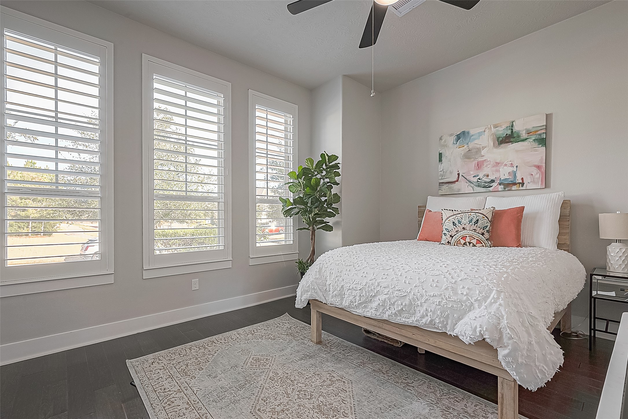 The first of three secondary rooms - this one faces the front of the home.  All rooms have wood flooring, Plantation shutters, and ceiling fans.