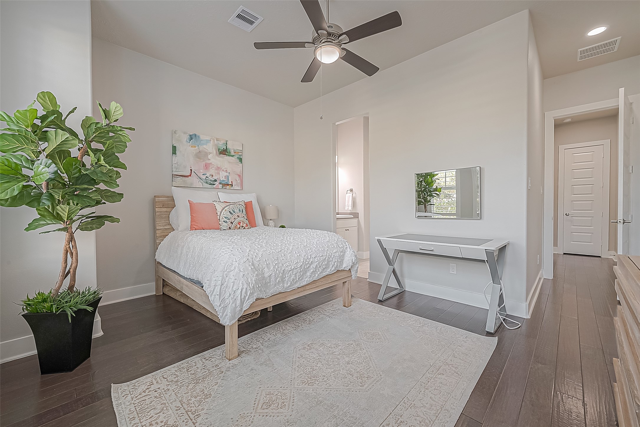 View of the front-facing bedroom and view into the Hollywood bath.