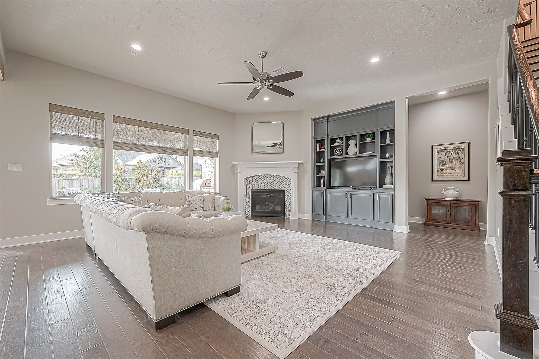 The living area is large enough to accommodate many different seating options.  The custom cabinetry houses a TV and has plenty of storage. The corner fireplace keeps things cozy on brisk mornings or cool nights.