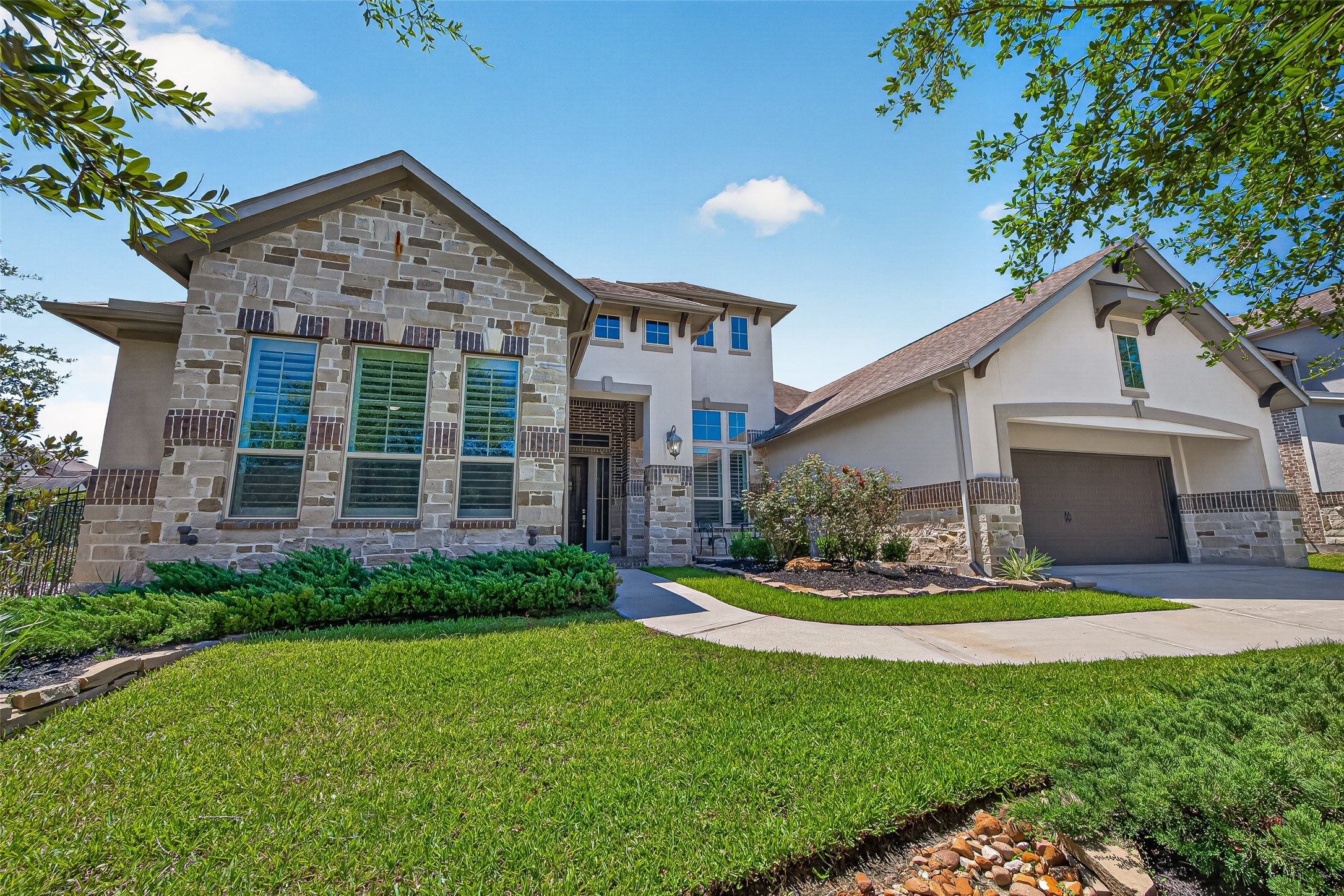 Located on the corner, only one side neighbor.  Beautiful stone, brick and stucco exterior.