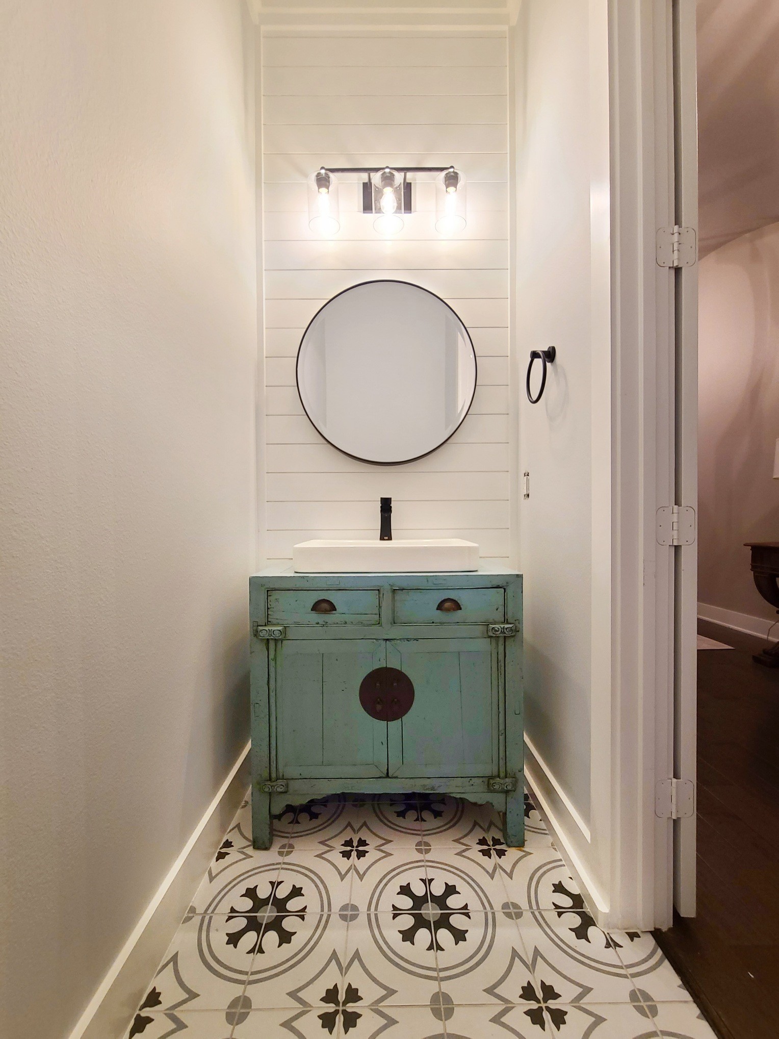 This is the downstairs half-bath - one of two in the home. Updated tile and custom vanity.
