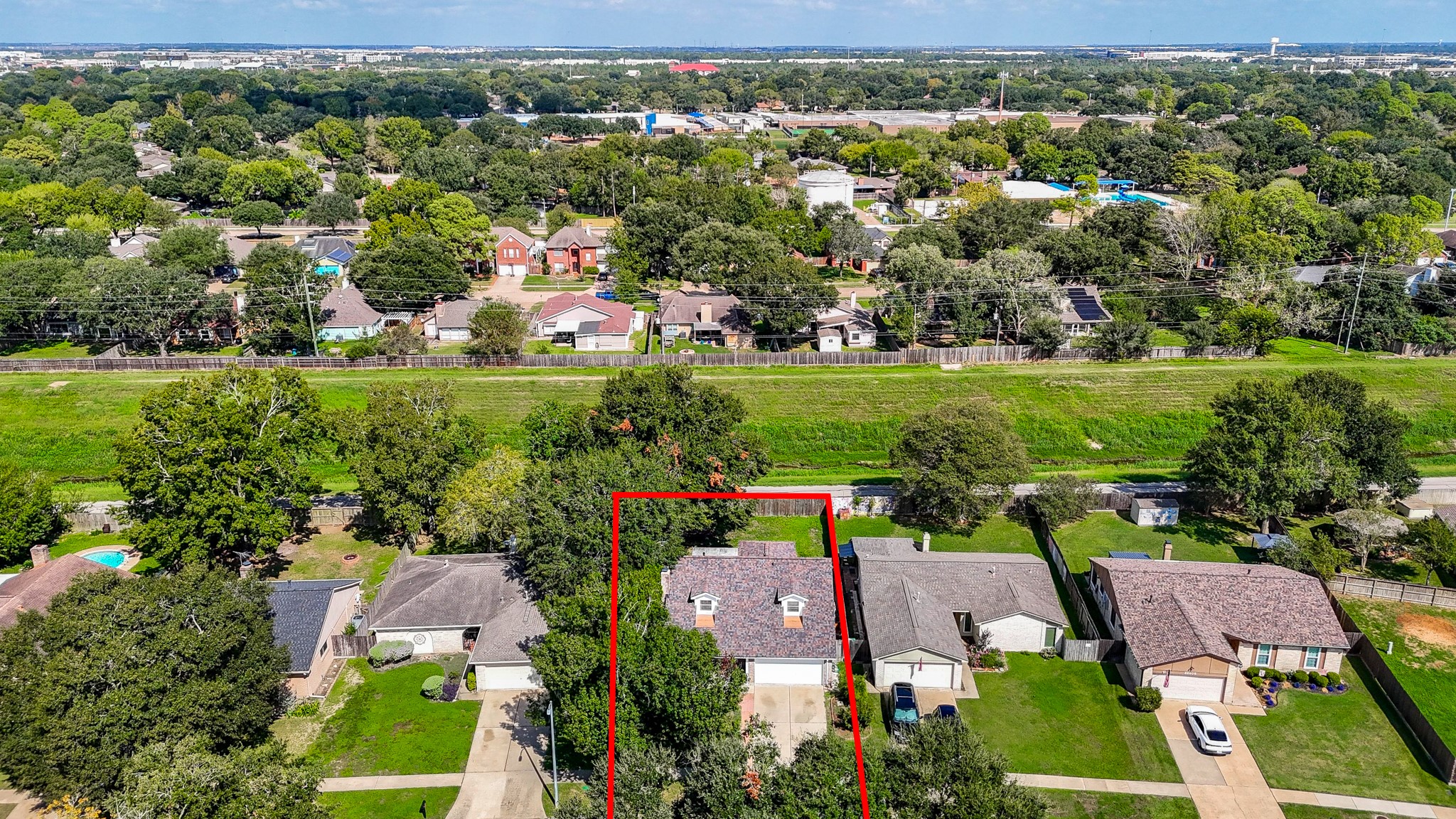 Another aerial view, looking from front of home to rear showing walking path behind property