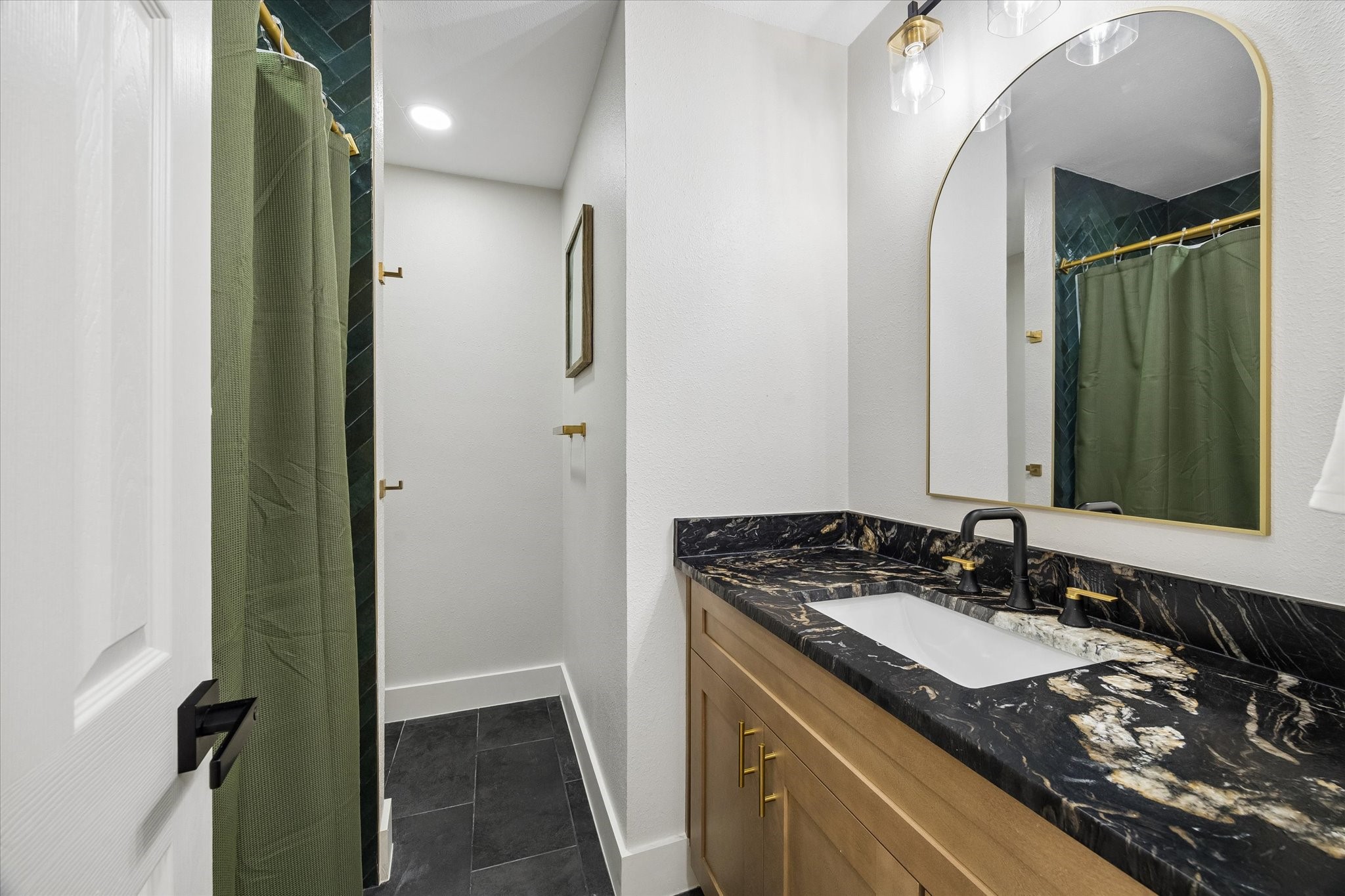 Secondary bathroom has been beautifully updated with fresh paint and modern fixtures.