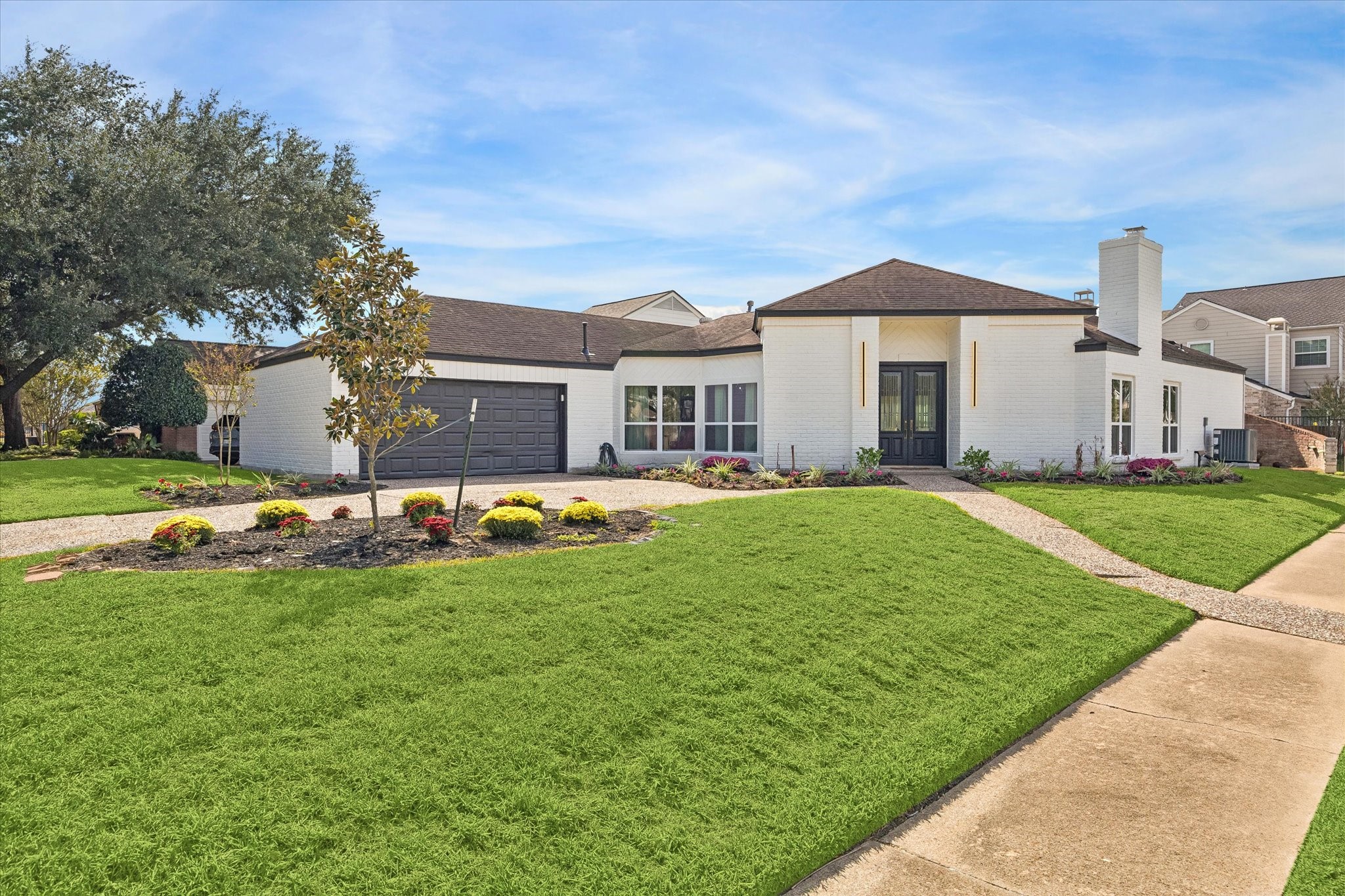 Charming single-story home on a corner lot with a modern exterior, featuring a spacious two-car garage, well-maintained landscaping, and a welcoming entryway. Charming single-story home on a corner lot with a modern exterior, featuring a spacious two-car garage, well-maintained landscaping, and a welcoming entryway.