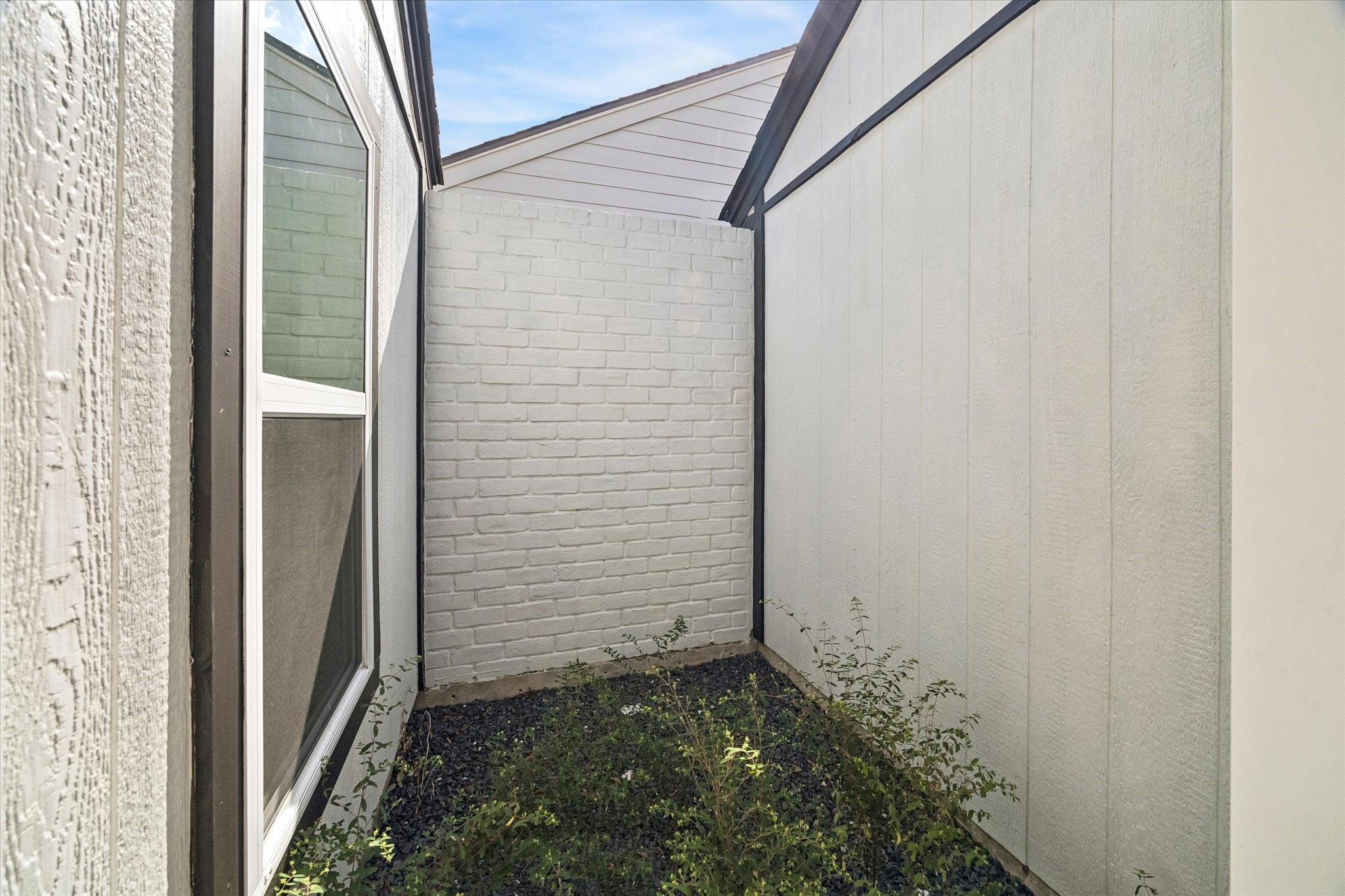 This charming side courtyard is the perfect place for a garden area.