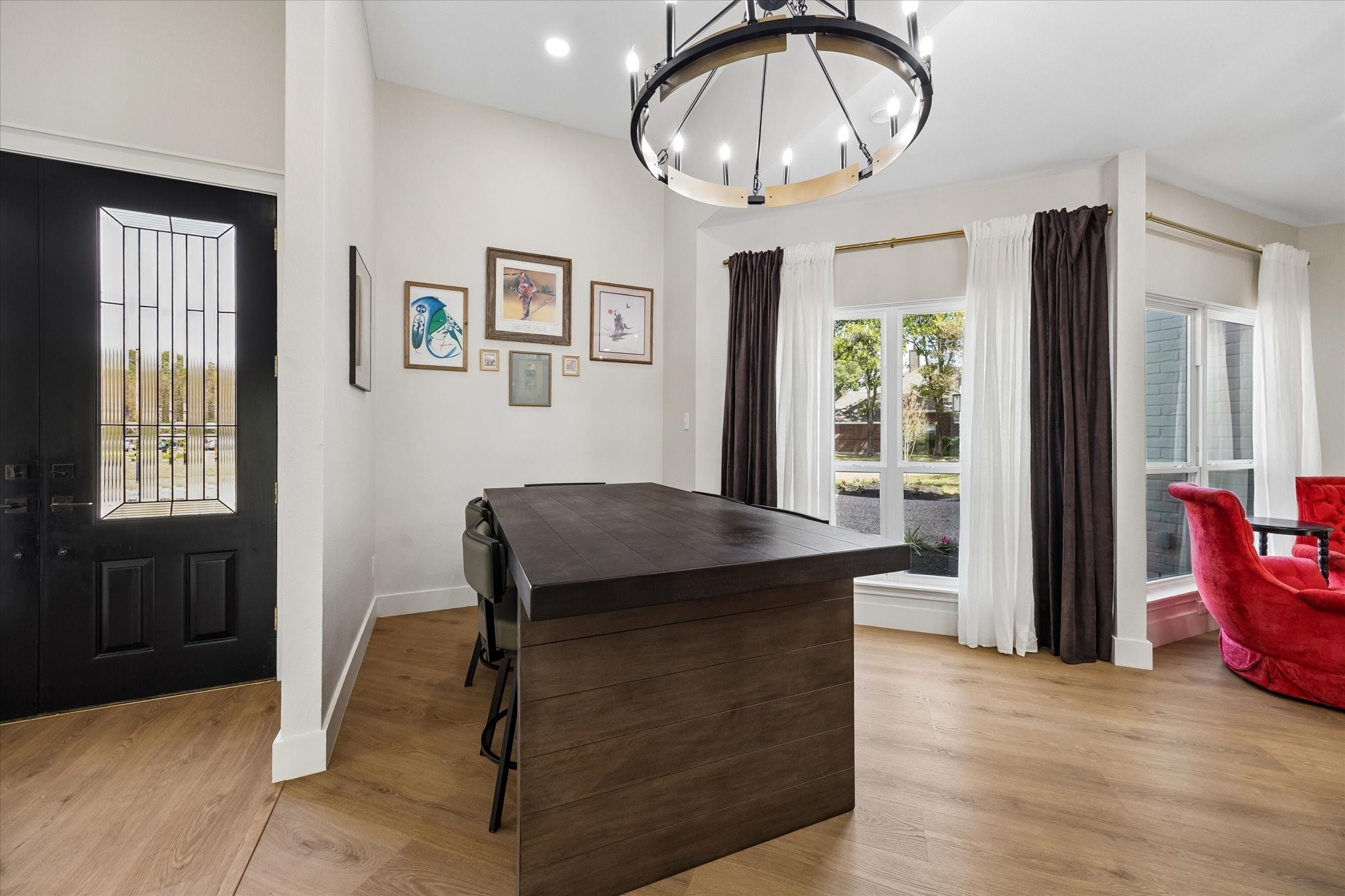Elegant dining area featuring a modern chandelier, large windows and conveniently flows into the open kitchen area.
