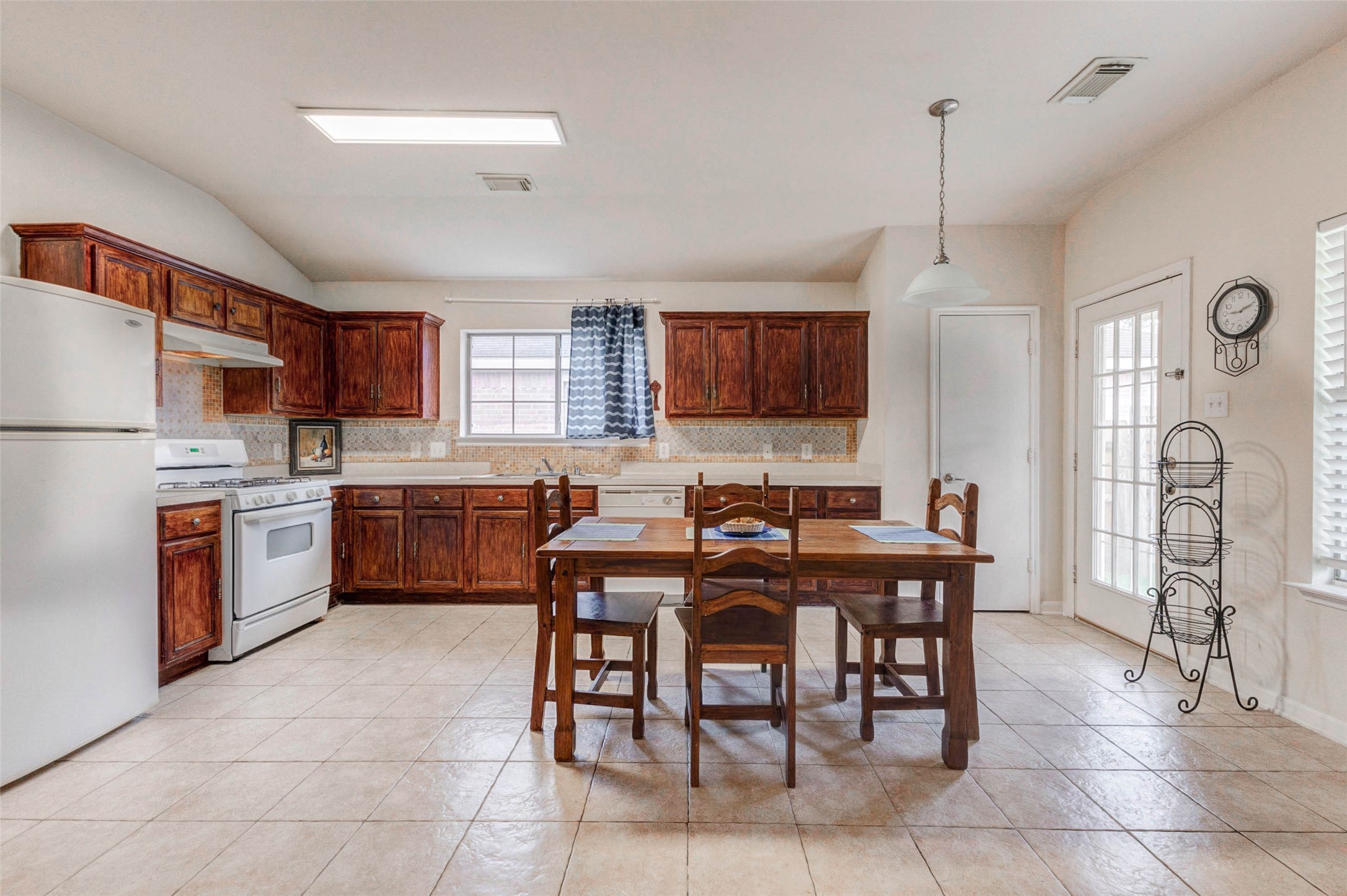Well-appointed kitchen featuring extensive cabinetry, durable countertops, and a practical layout that maximizes efficiency. A gas range and ample prep space make cooking a breeze, while the adjacent dining area keeps everything connected. Bright lighting and clean finishes create a welcoming environment for everyday use.