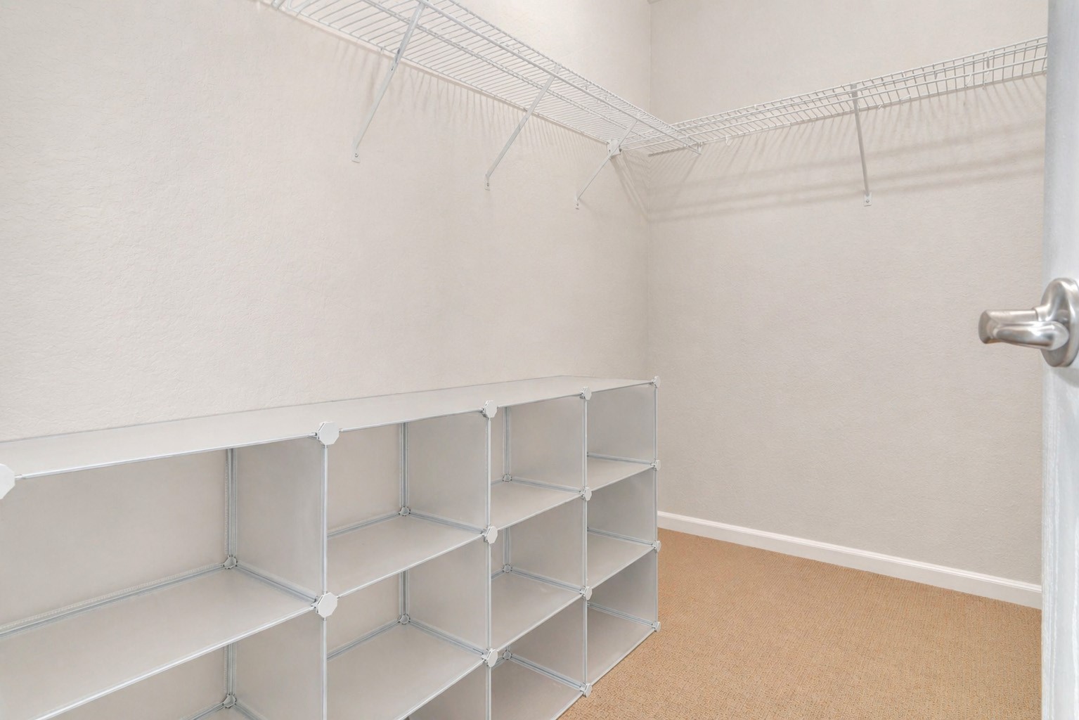 Large walk-in closet providing ample storage with built-in shelving and hanging space. Designed for organization and convenience, this closet easily accommodates a full wardrobe and accessories. A functional and practical feature that enhances everyday living.