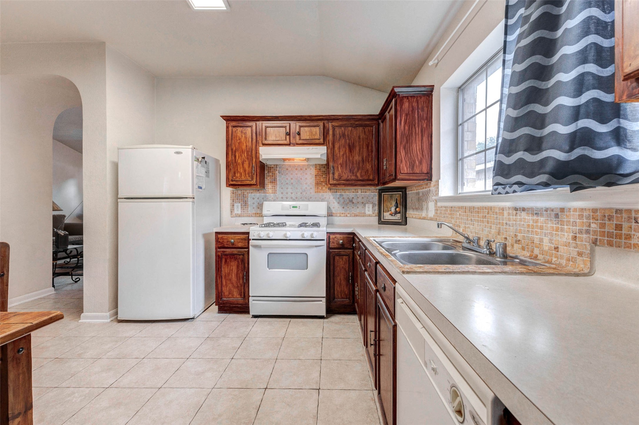 Seamless transition between dining and living areas creates a spacious, connected environment perfect for entertaining. The open layout allows for flexible furniture arrangements, while natural light and neutral finishes enhance the overall warmth and livability of the home.