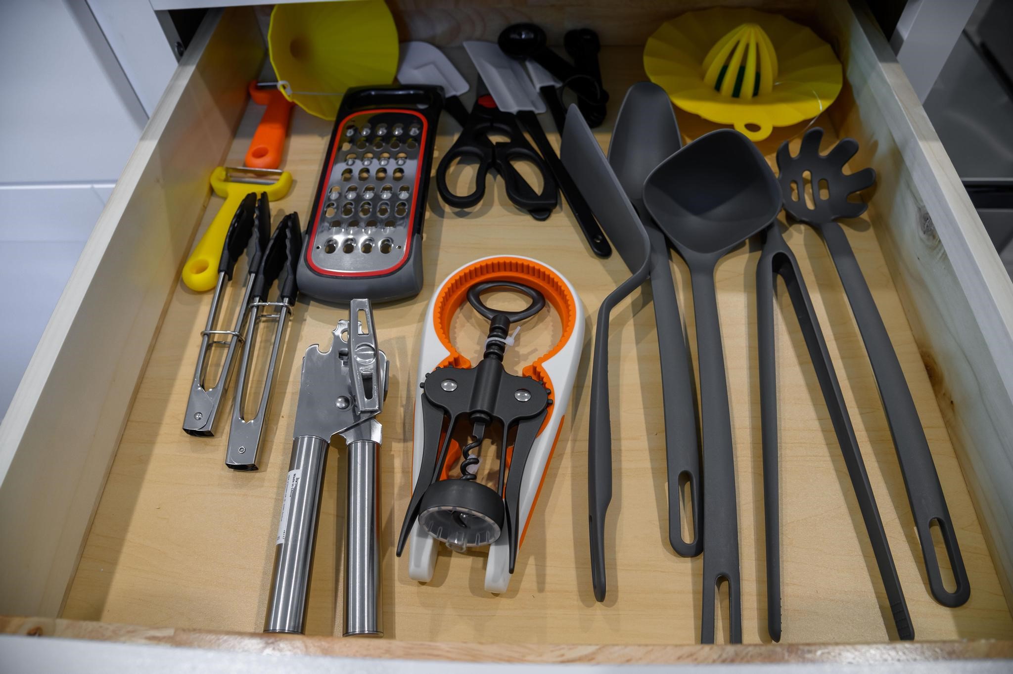 A well-organized kitchen drawer featuring essential utensils and gadgets ensures easy access and efficiency for all your culinary needs.