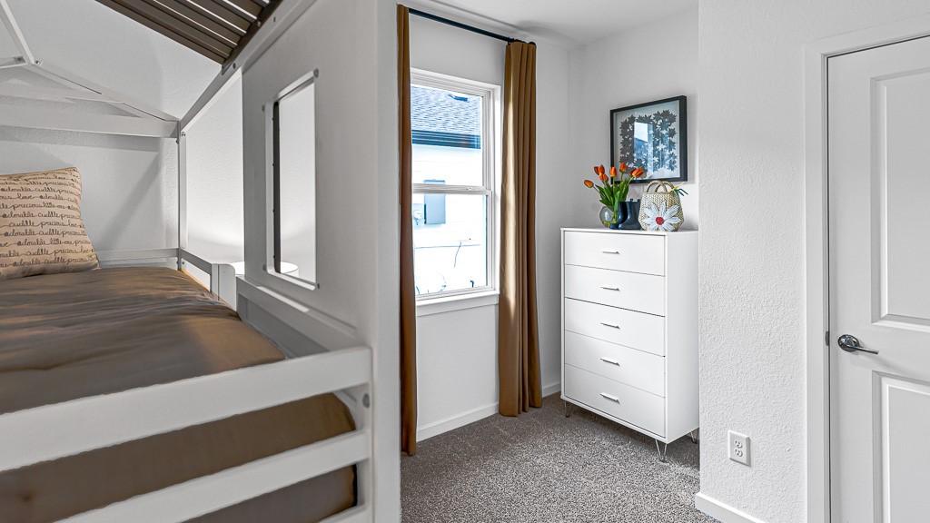 Bedroom 3 has a great window for ample natural lighting and custom drapery, recessed furniture niche for a dresser, and a walk-in closet.