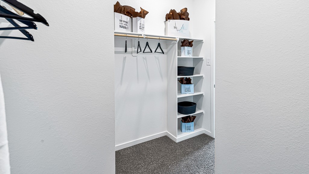 Spacious walk-in closet in primary suite.