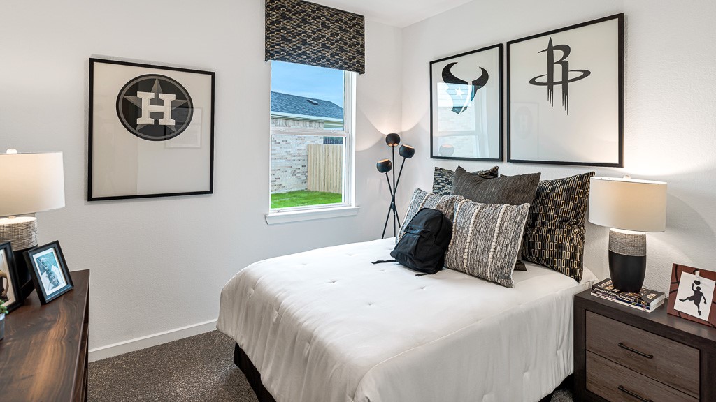 Bedroom 4 has designer white walls, new carpeting in appealing warm gray, and window has a custom valance for a sharp modern look.