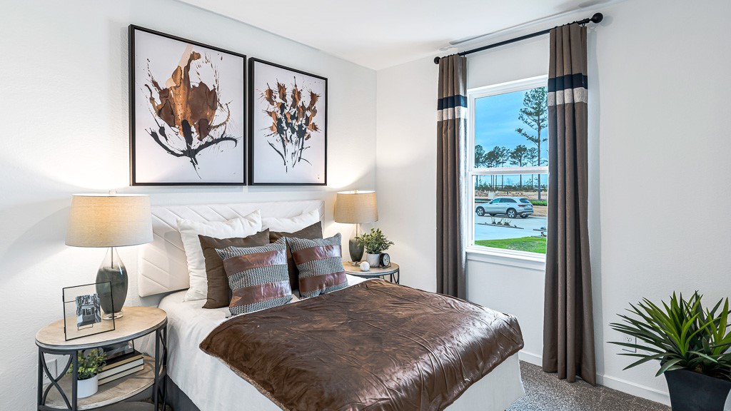 Bedroom 2 is upfront with great window and custom drapery adds high end style. Designer white walls are neutral and appealing.
