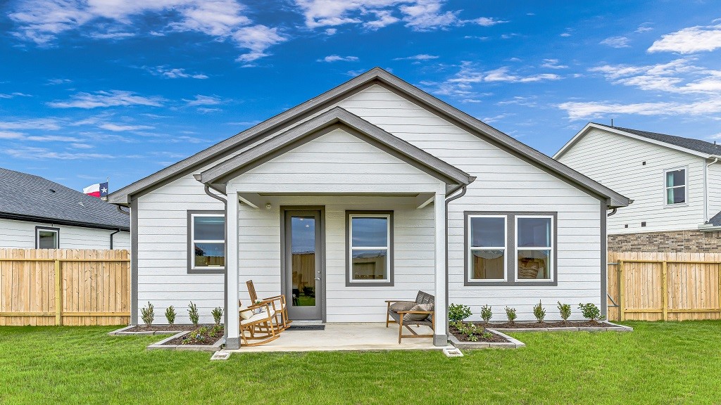 Landscaped beds along back of home and covered lanai add the perfect touch of greenery and softness.