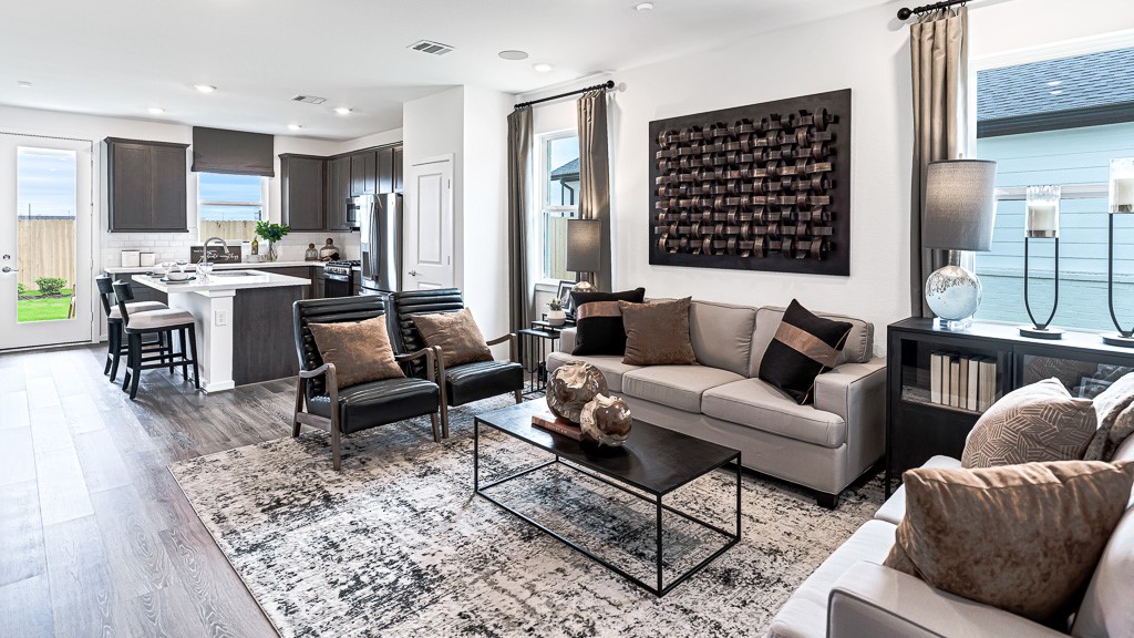 Open family room and kitchen have an inviting atmosphere with fabulous hardwood floors and designer white walls.