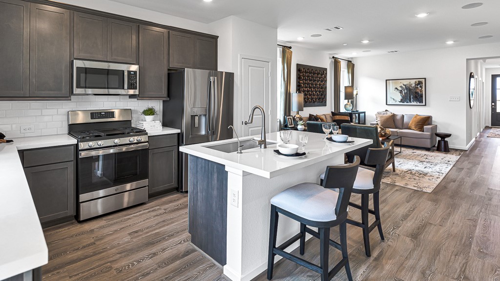 Kitchen island has stainless steel undermount sink, modern faucet including a filtered water faucet and dishwasher.