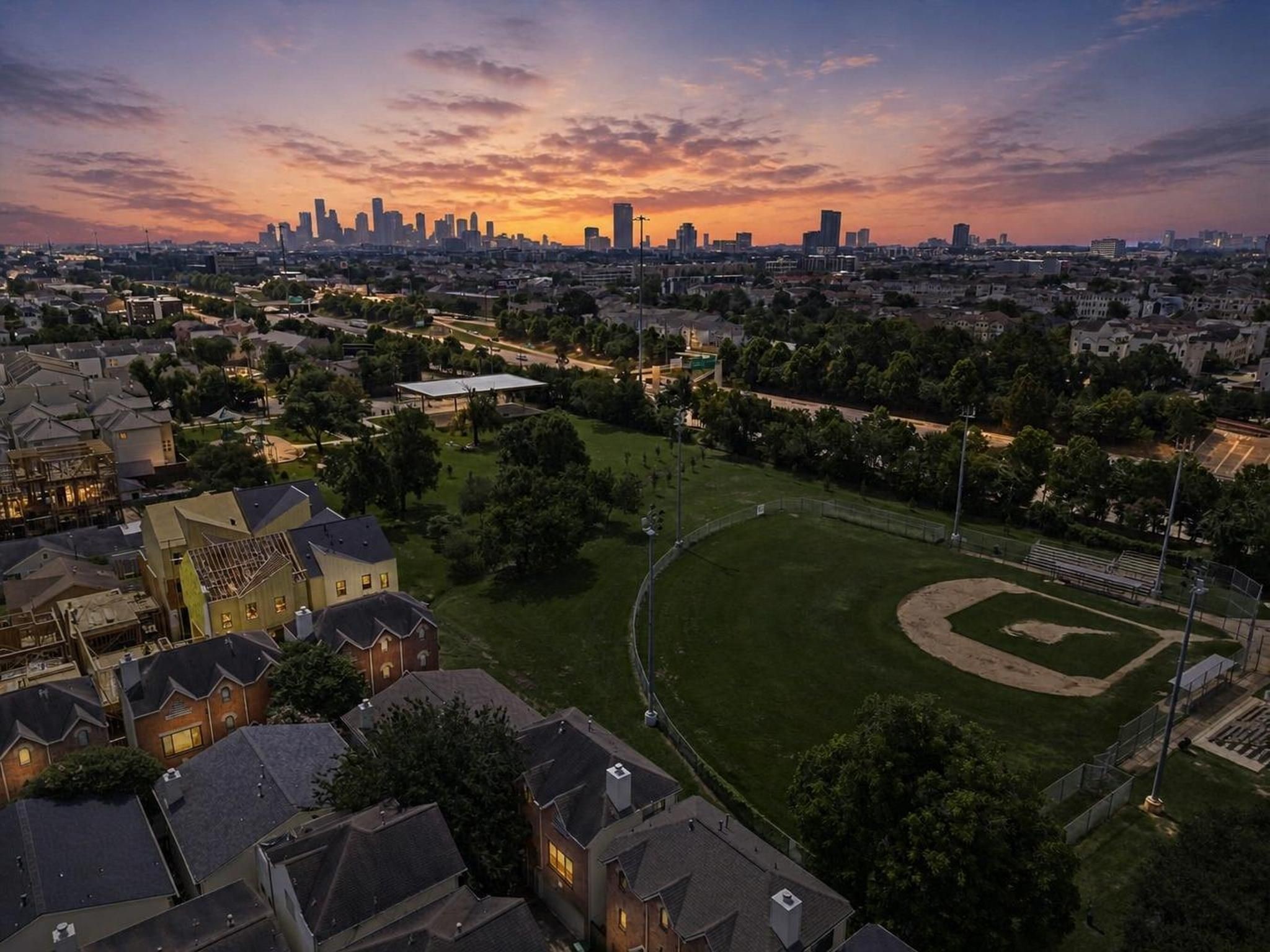 The aerial view captures the homes Cottage Grove setting with the Houston skyline in the distance. It tells the story of a private residential pocket connected closely to the energy of the city.