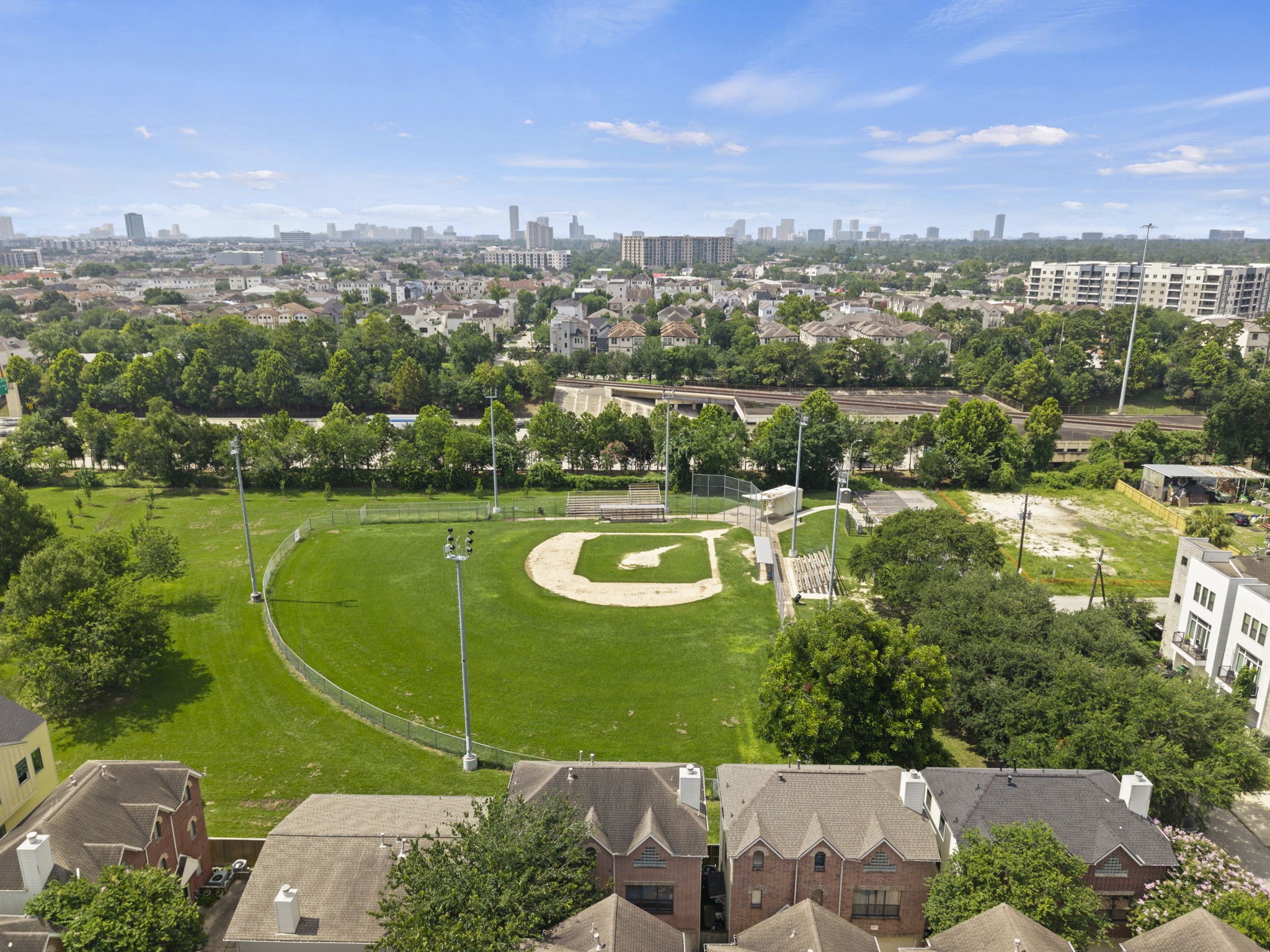 From above, the location becomes one of the homes strongest features. The surrounding neighborhood, nearby green space, and skyline backdrop give the property a true inner-loop feel.