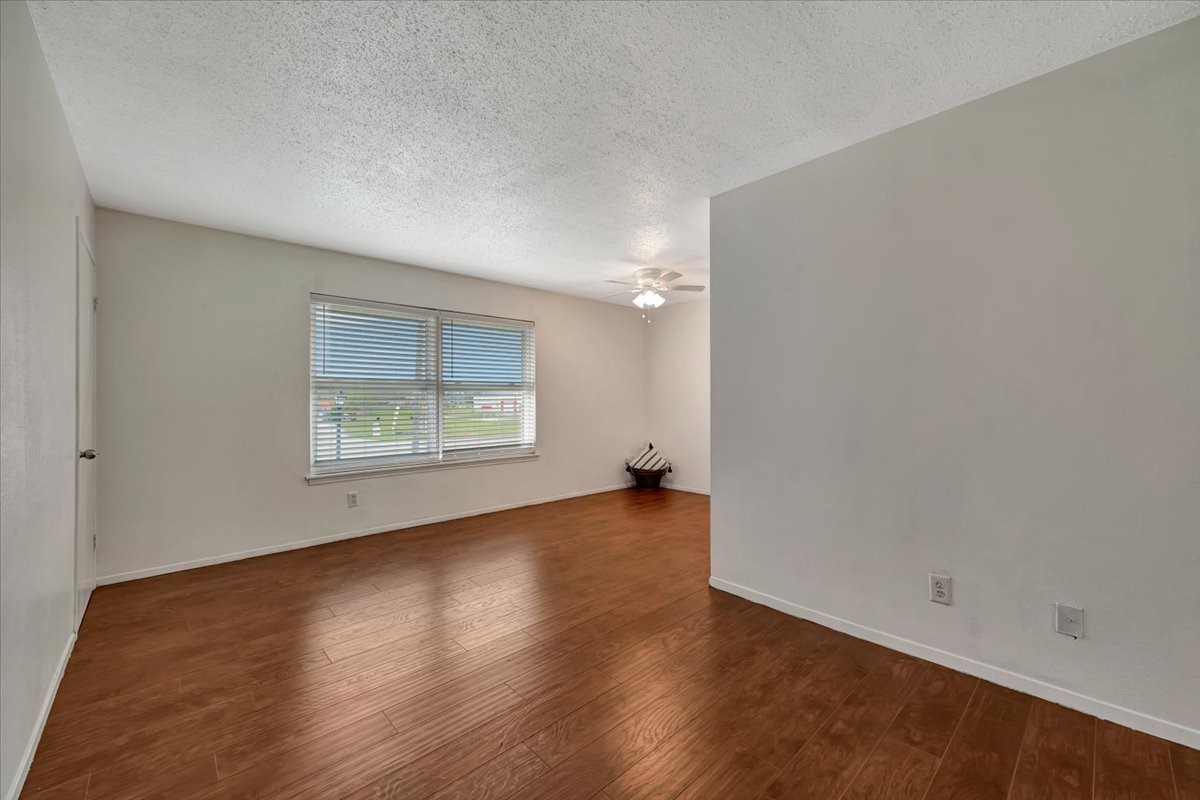 From the entry, this view highlights the spacious living room to the left, showcasing its bright and open layout with seamless flow and natural light throughout.