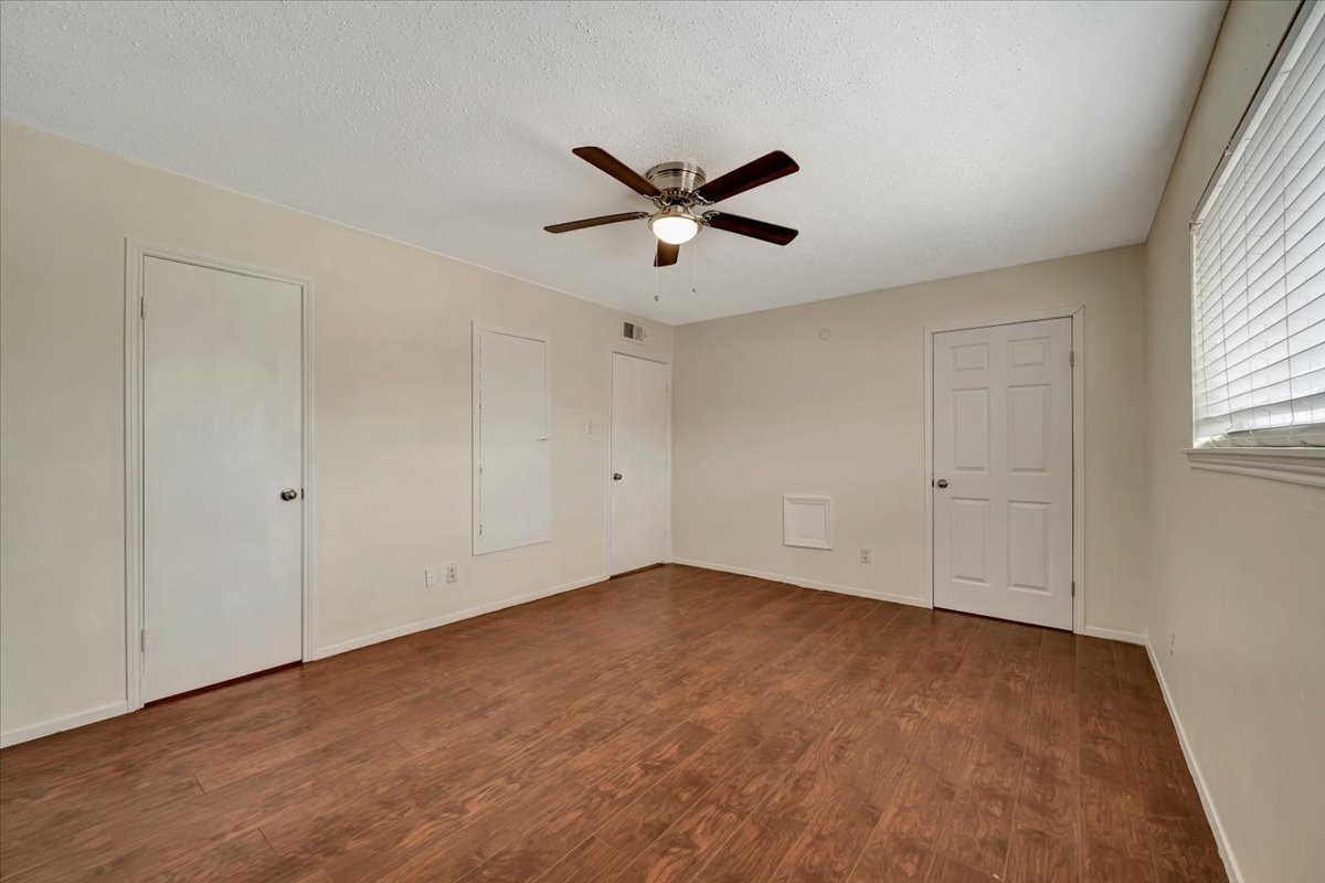 The bedroom boasts laminate flooring, a ceiling fan, and two large walk-in closetsan exceptional feature for a one-bedroom property!