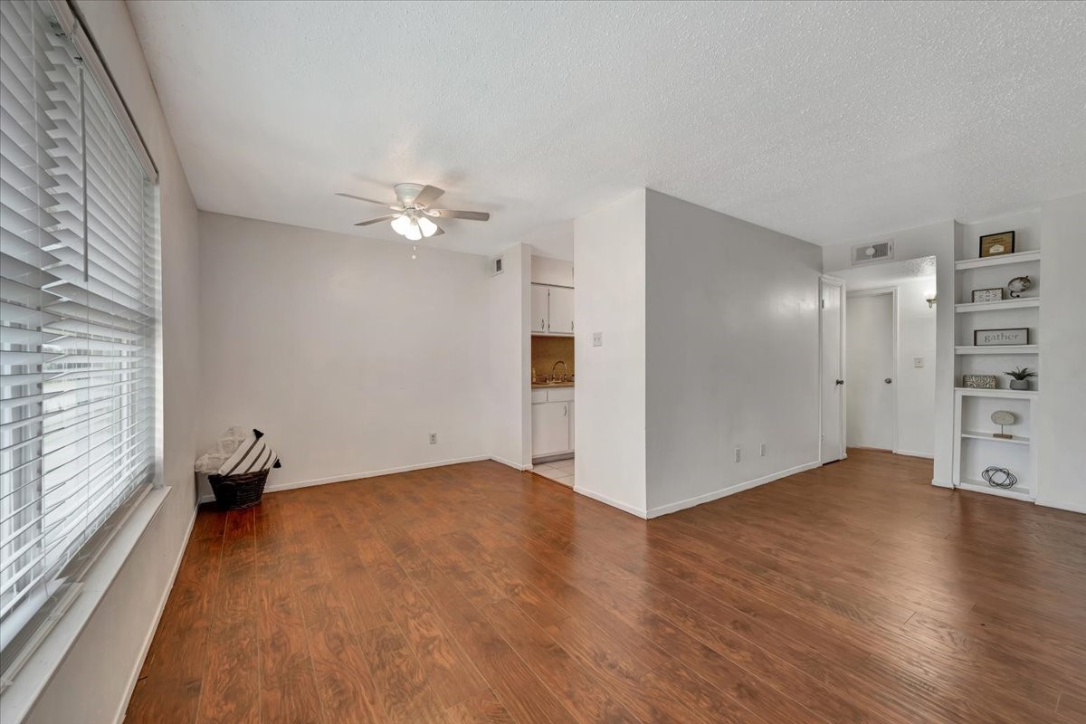 Featuring an open layout, laminate flooring, and a ceiling fan in the dining area for added comfort.