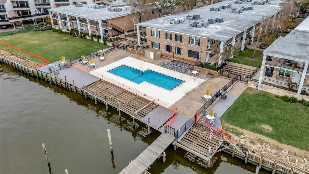 The pool area offers a peaceful retreat, surrounded by lush green spaces and just steps from Clear Lake.