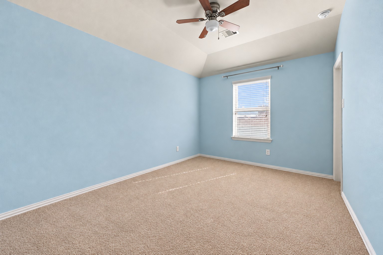 Third upstairs bedroom offers a bright and inviting soft blue walls,  and plenty of natural light, creating a comfortable and welcoming space!
