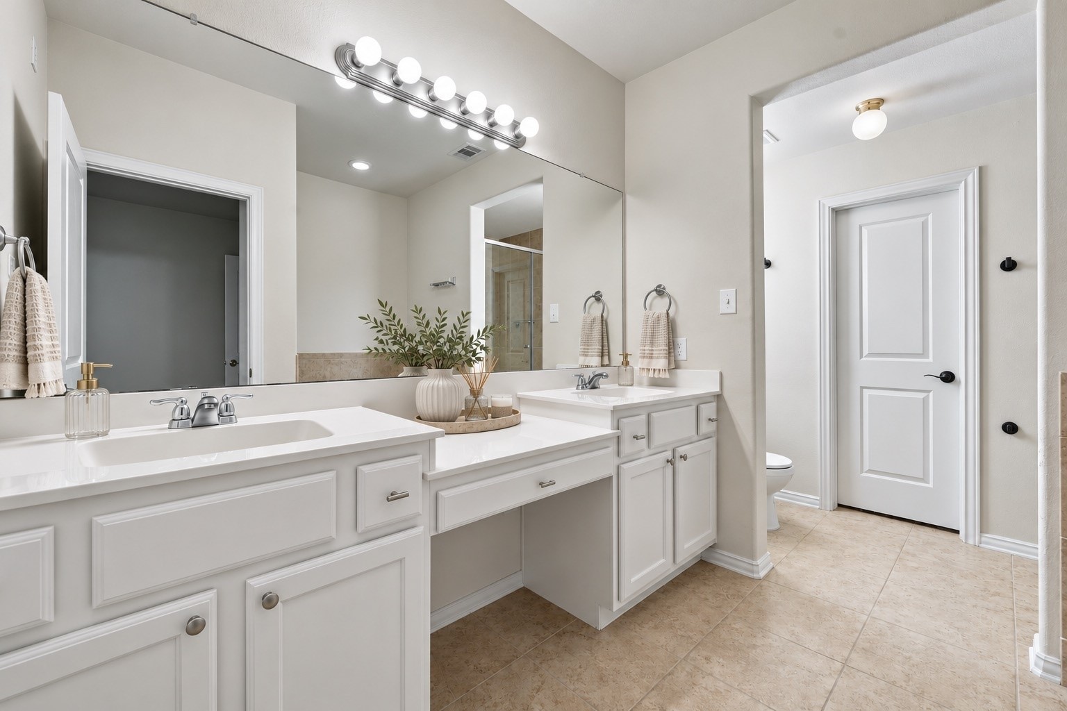This spacious primary bathroom features dual vanities, a large mirror, and plenty of countertop space for everyday convenience.
*Virtually staged.*