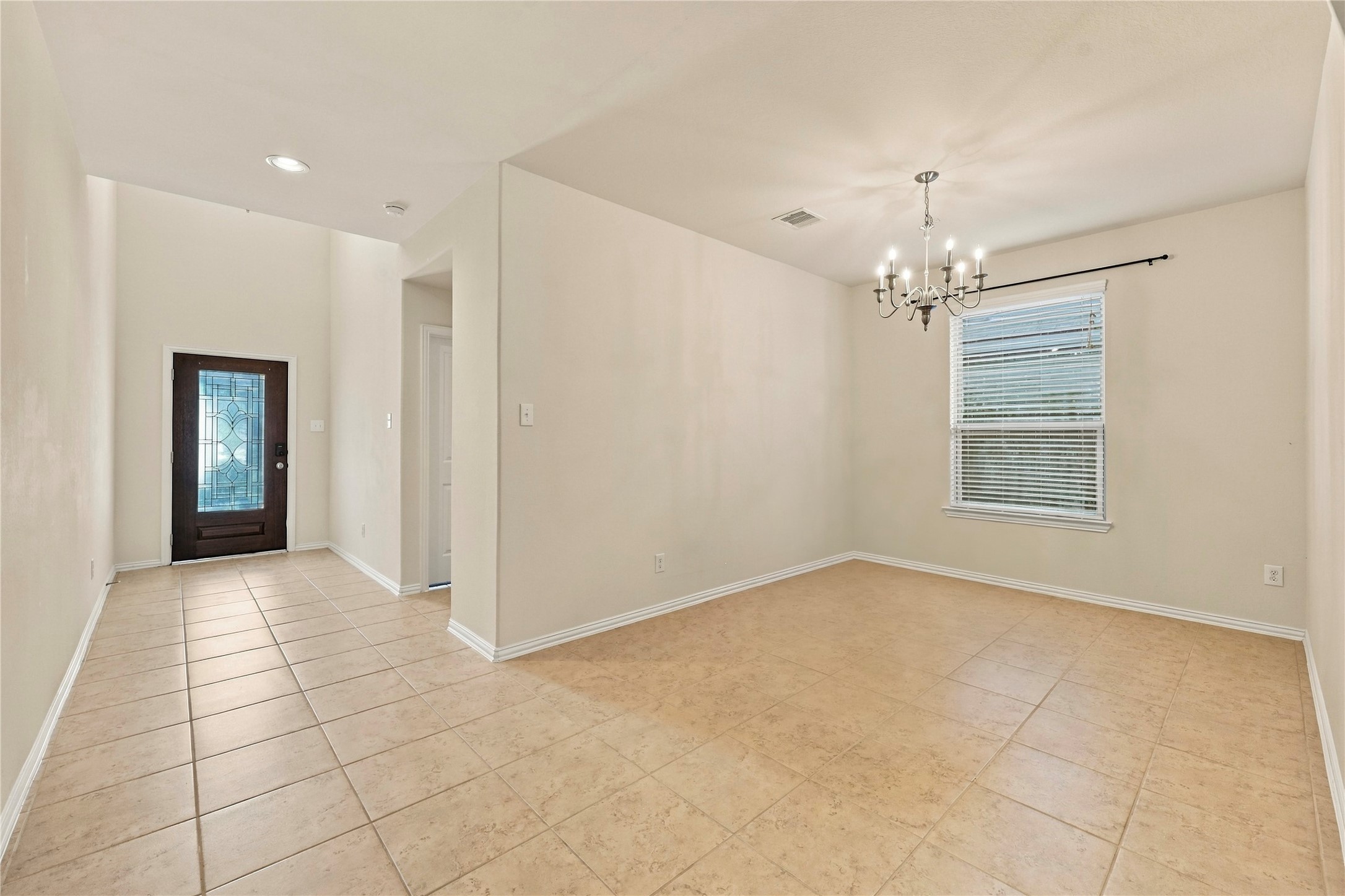 A bright and welcoming entryway flows seamlessly into a spacious formal dining area, perfect for hosting gatherings.