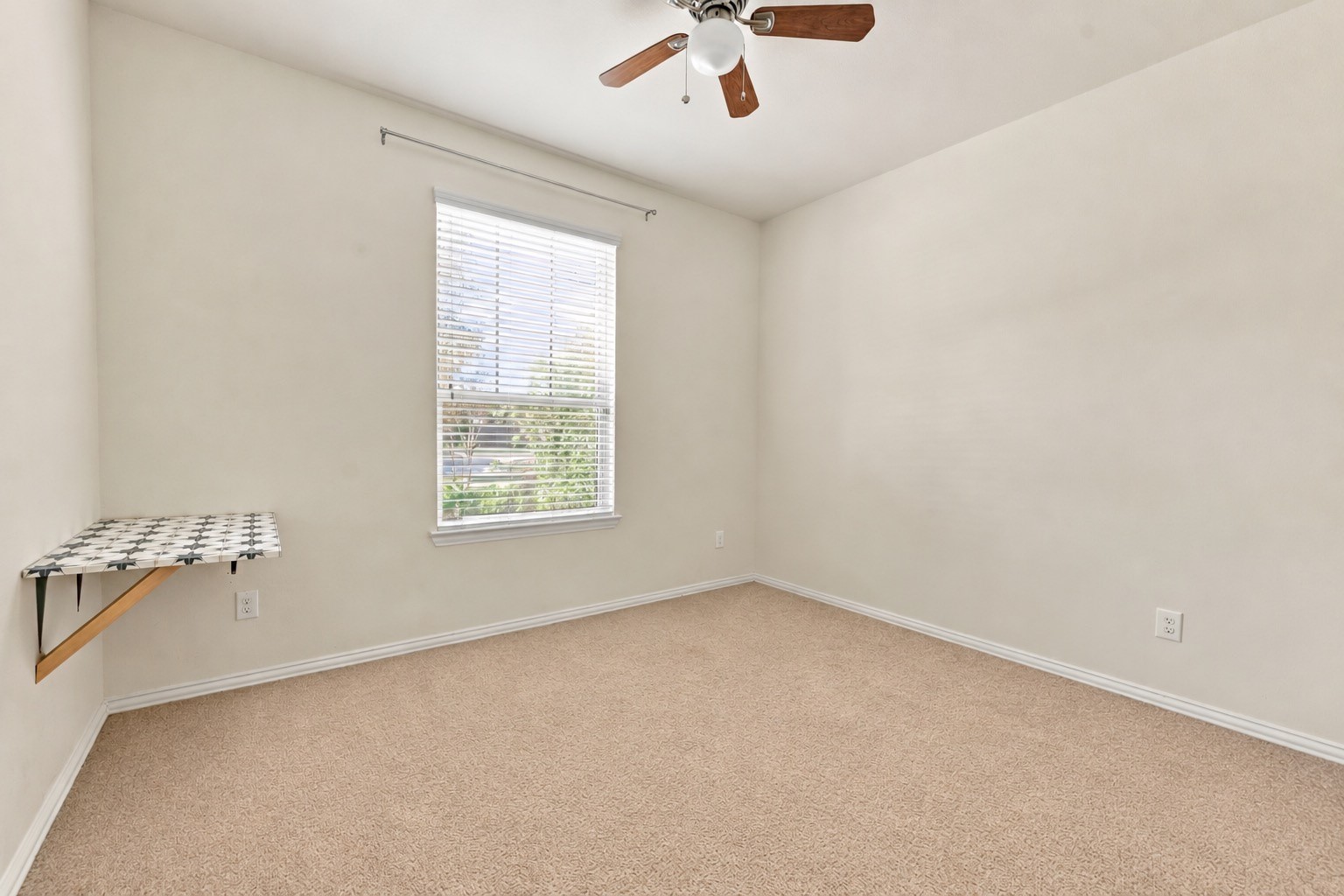 This versatile downstairs room overlooks the front of the home and offers plenty of possibilities for a home office, hobby room, or creative space, complete with a built in work surface!