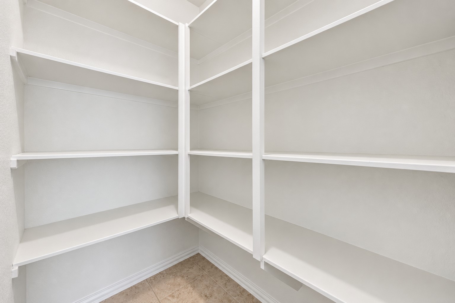 Spacious corner pantry with plenty shelf storage!