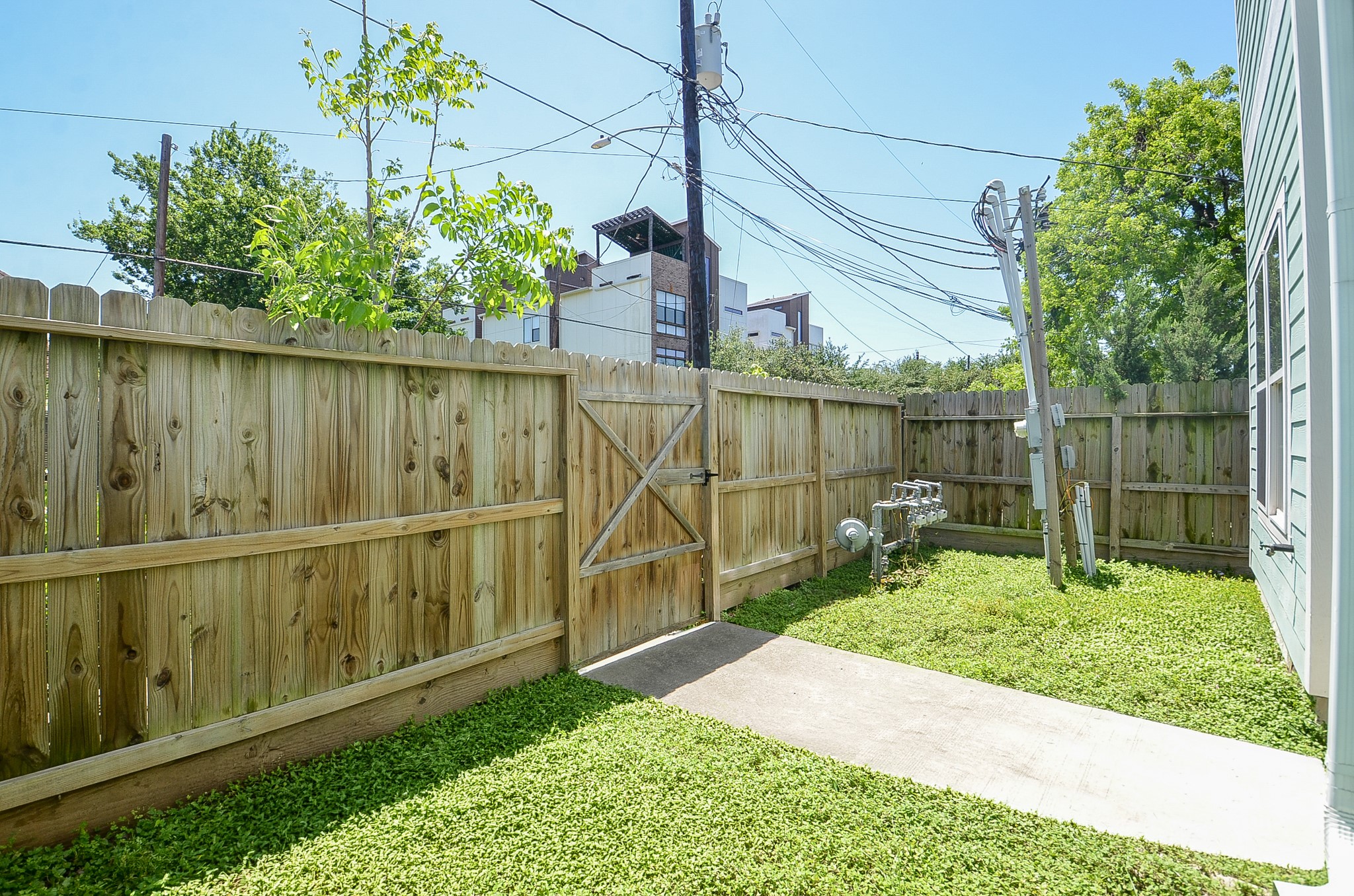 Private fenced outdoor space with gate access to the sidewalk.