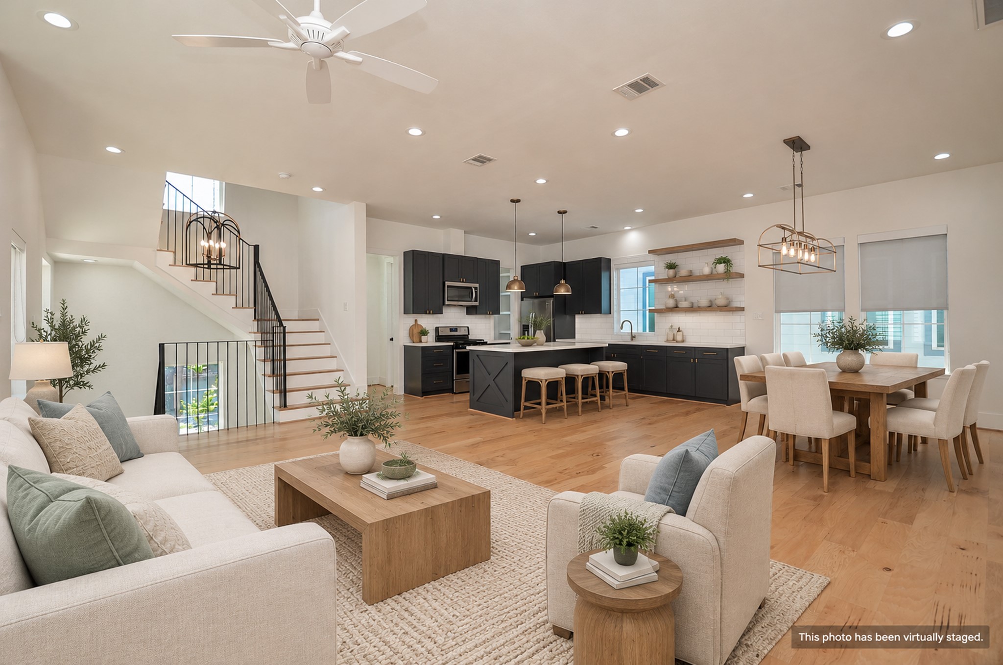 The second floor connects living, dining, and kitchen spaces in one open layout.