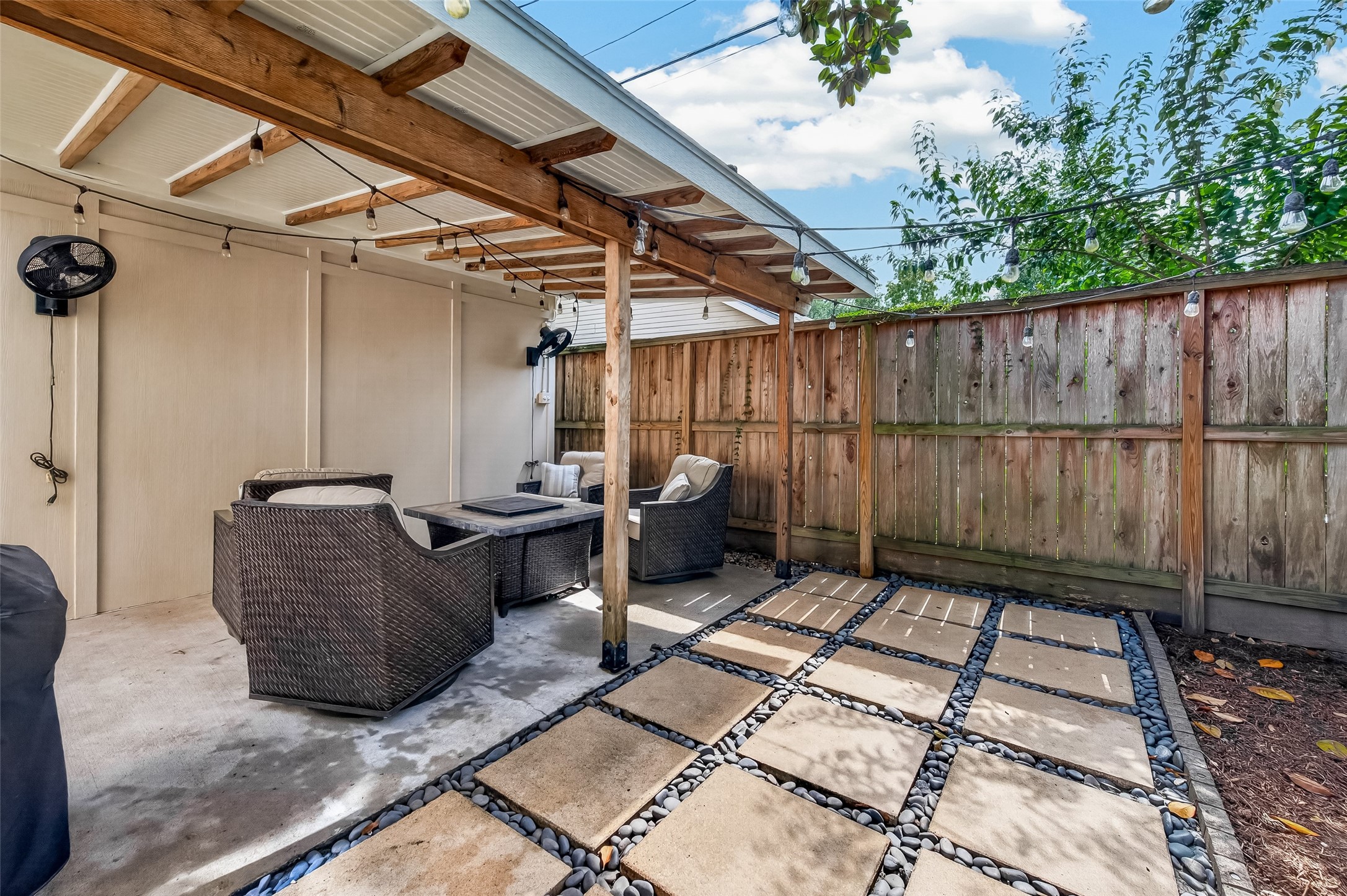Another view of sitting and fenced backyard