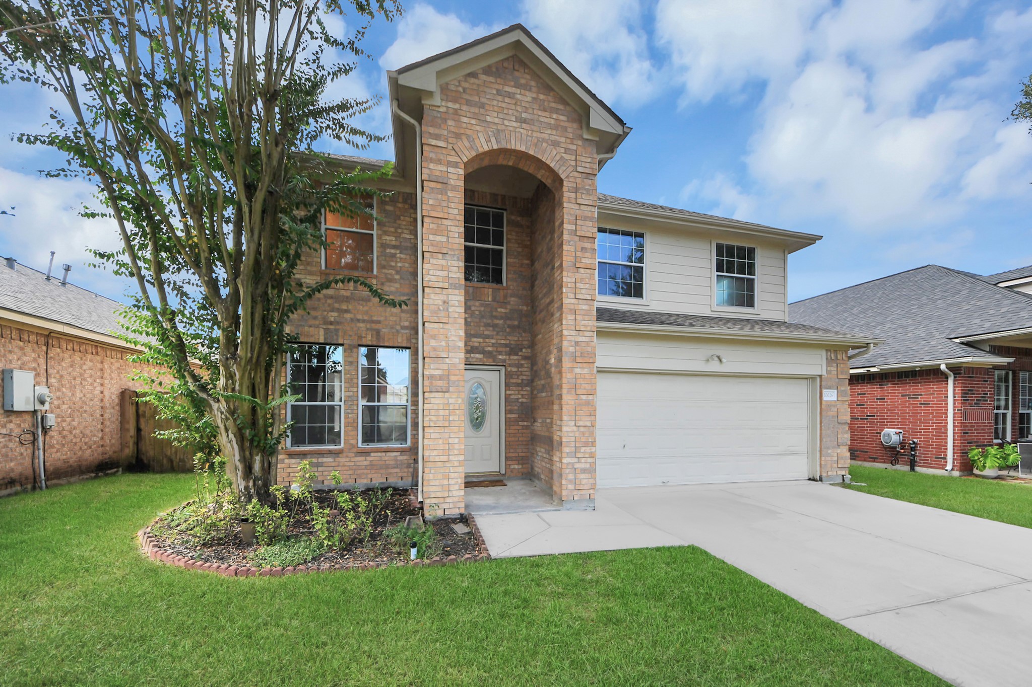 Beautiful two-story brick home with a welcoming arched entryway, large windows, and a well-maintained lawn. The attached two-car garage offers convenience and ample parking. Beautiful two-story brick home with a welcoming arched entryway, large windows, and a well-maintained lawn. The attached two-car garage offers convenience and ample parking.