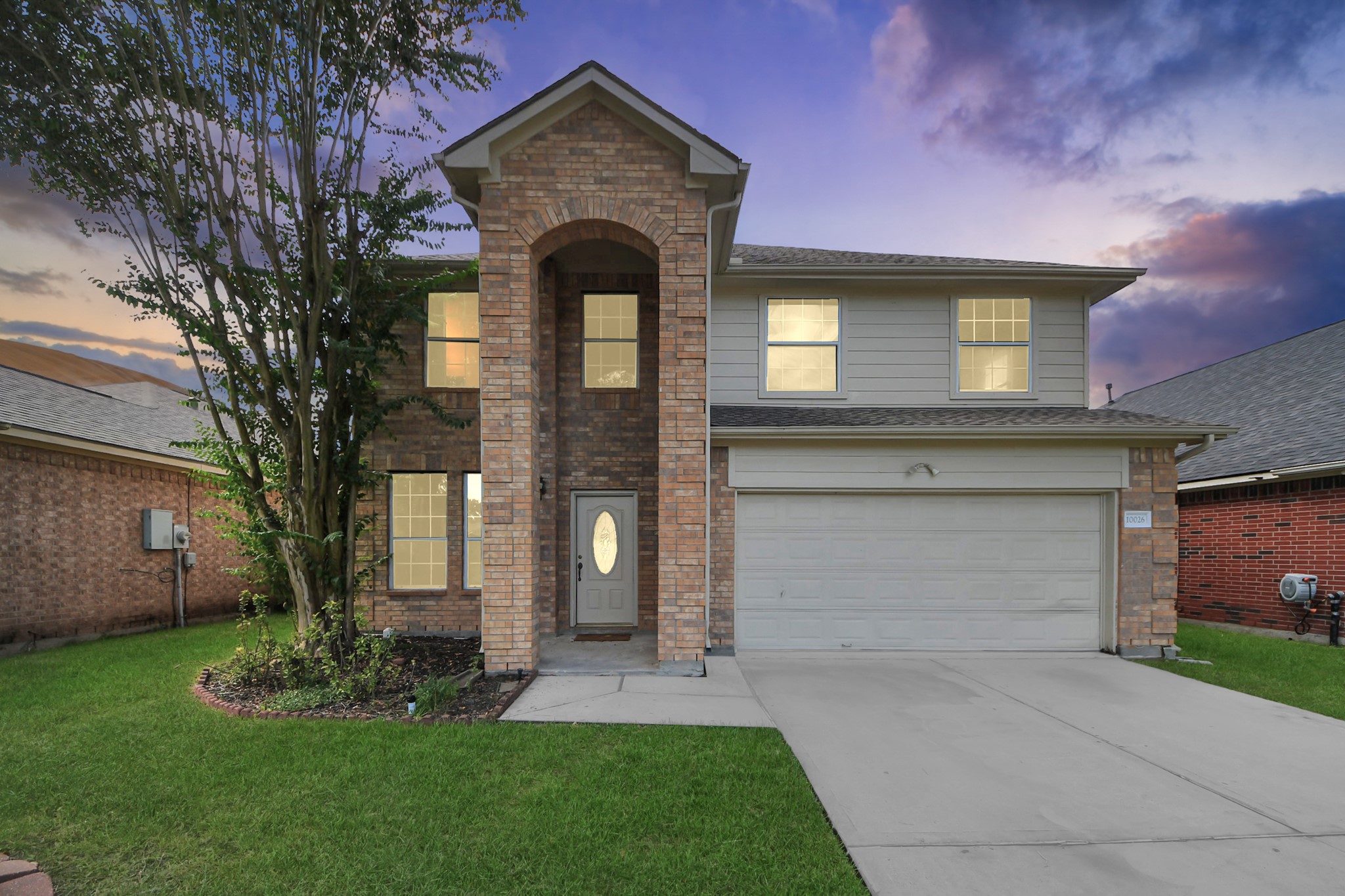 Charming two-story brick home with a welcoming archway entrance, nestled in a serene neighborhood with a spacious two-car garage and well-maintained lawn. Charming two-story brick home with a welcoming archway entrance, nestled in a serene neighborhood with a spacious two-car garage and well-maintained lawn.