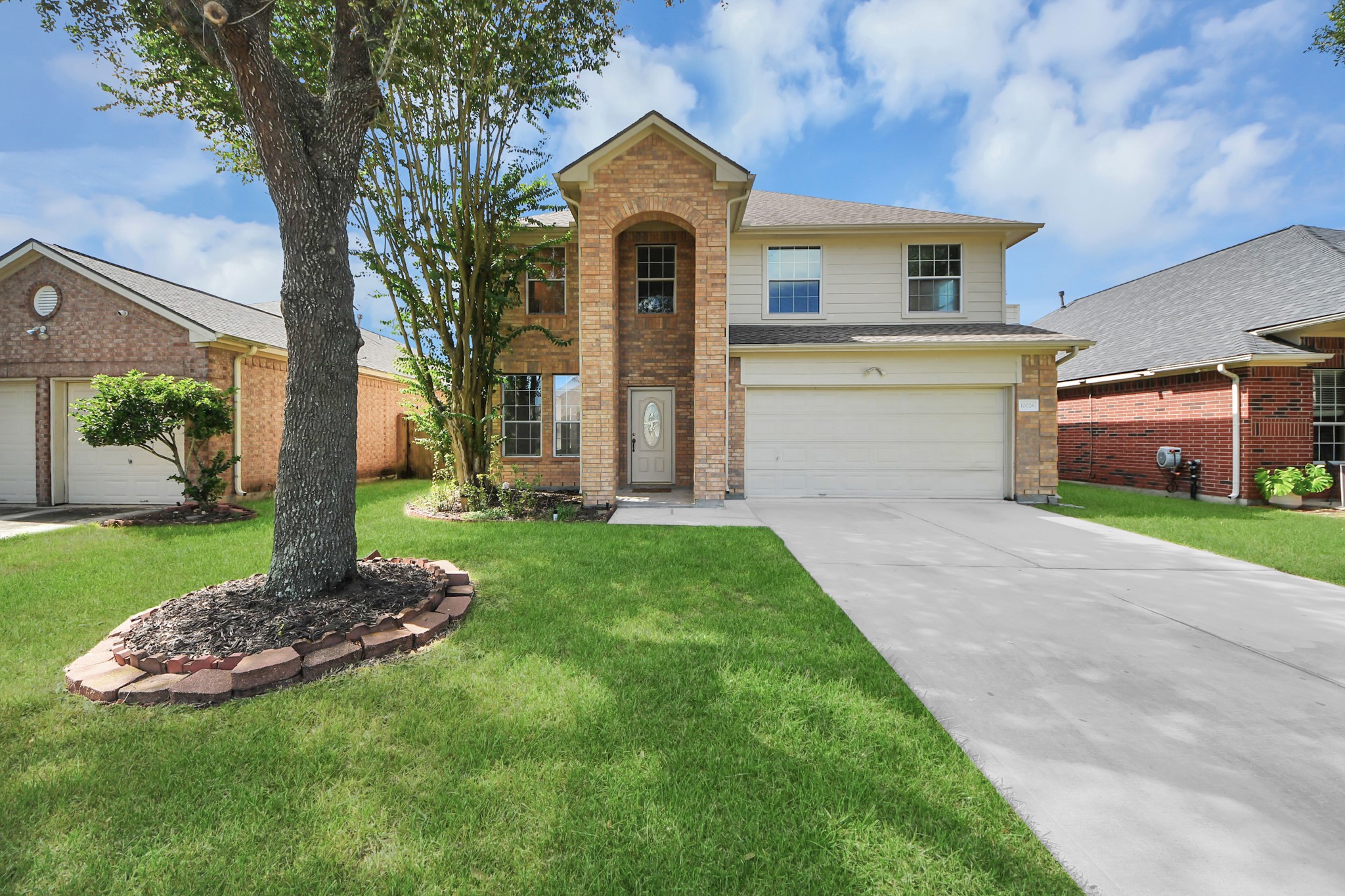 Charming two-story brick home with a welcoming arched entry, spacious driveway, and well-maintained front yard accented by mature trees. Charming two-story brick home with a welcoming arched entry, spacious driveway, and well-maintained front yard accented by mature trees.