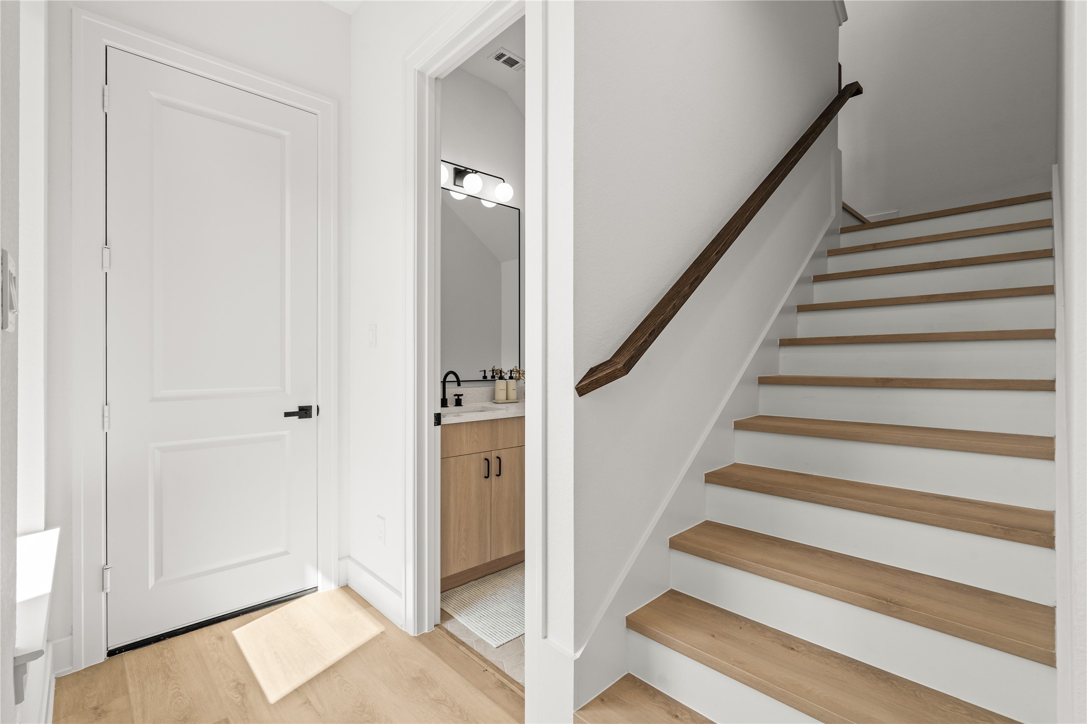 This view shows how the main floors connects. With a private, tucked-away powder room.