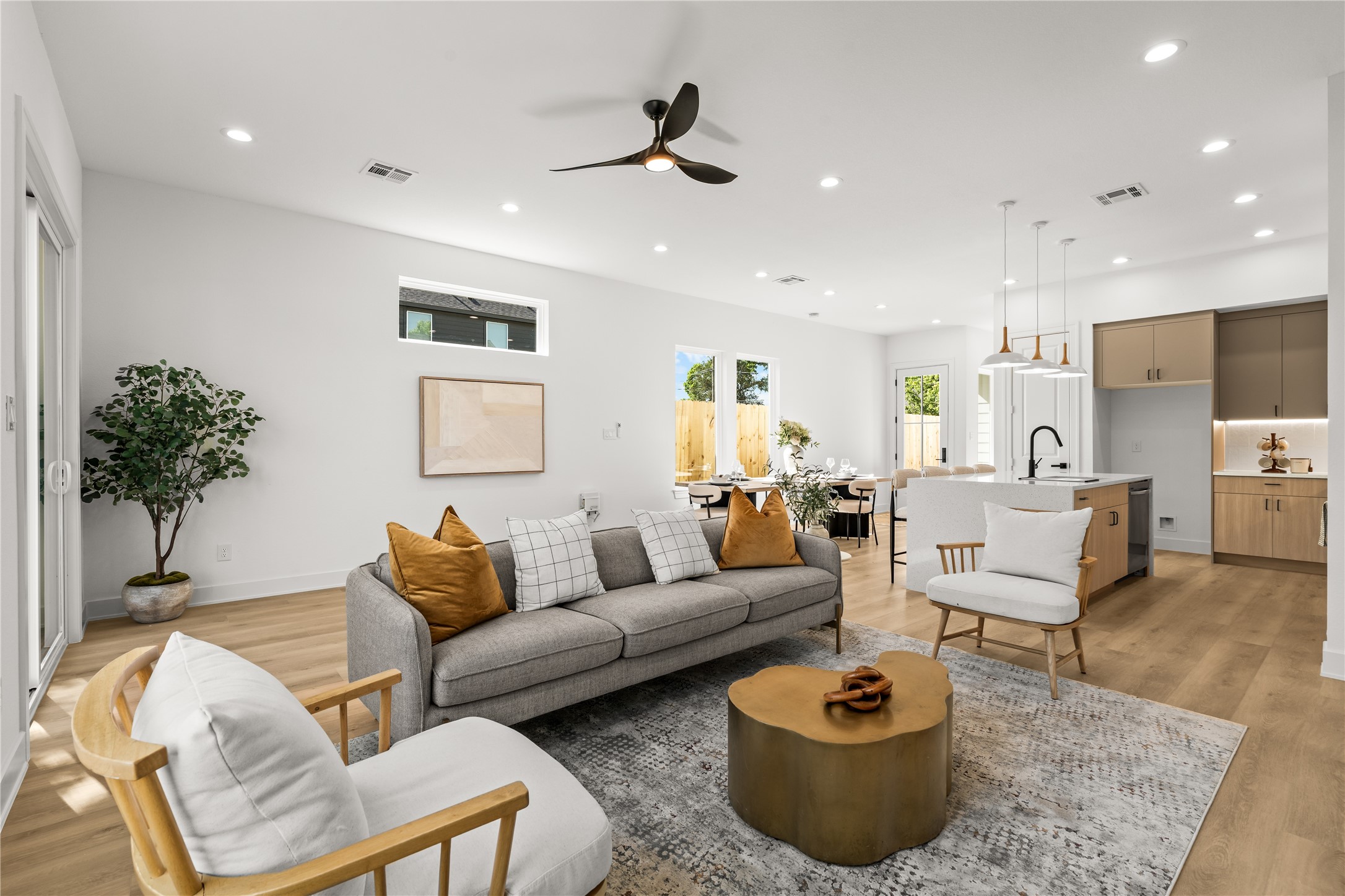 This view shows just how spacious the open-concept living area is. The layout easily fits a large sofa and accent chairs, keeping the living room, dining area, and kitchen completely connected and open.