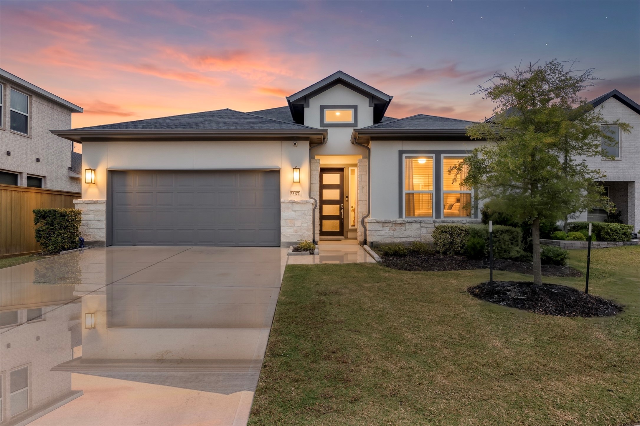 Elegant home with a warm, inviting facade and beautifully landscaped front yard.