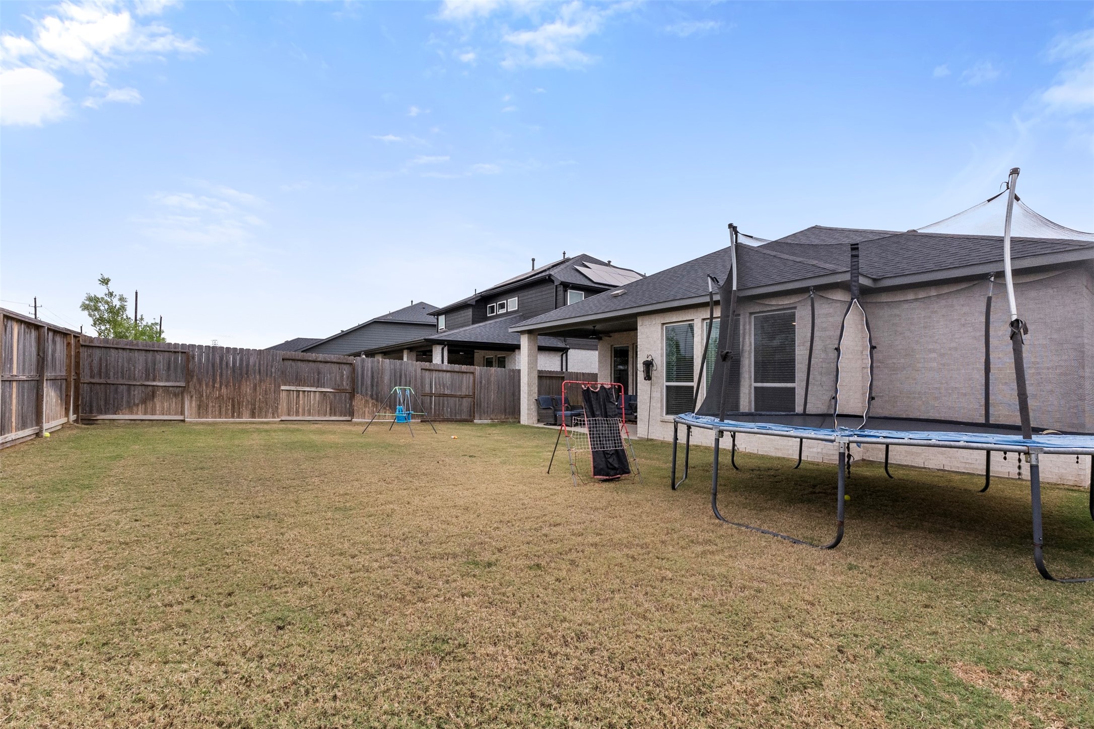 A large, fully fenced backyard with no back neighbors and a full sprinkler system.