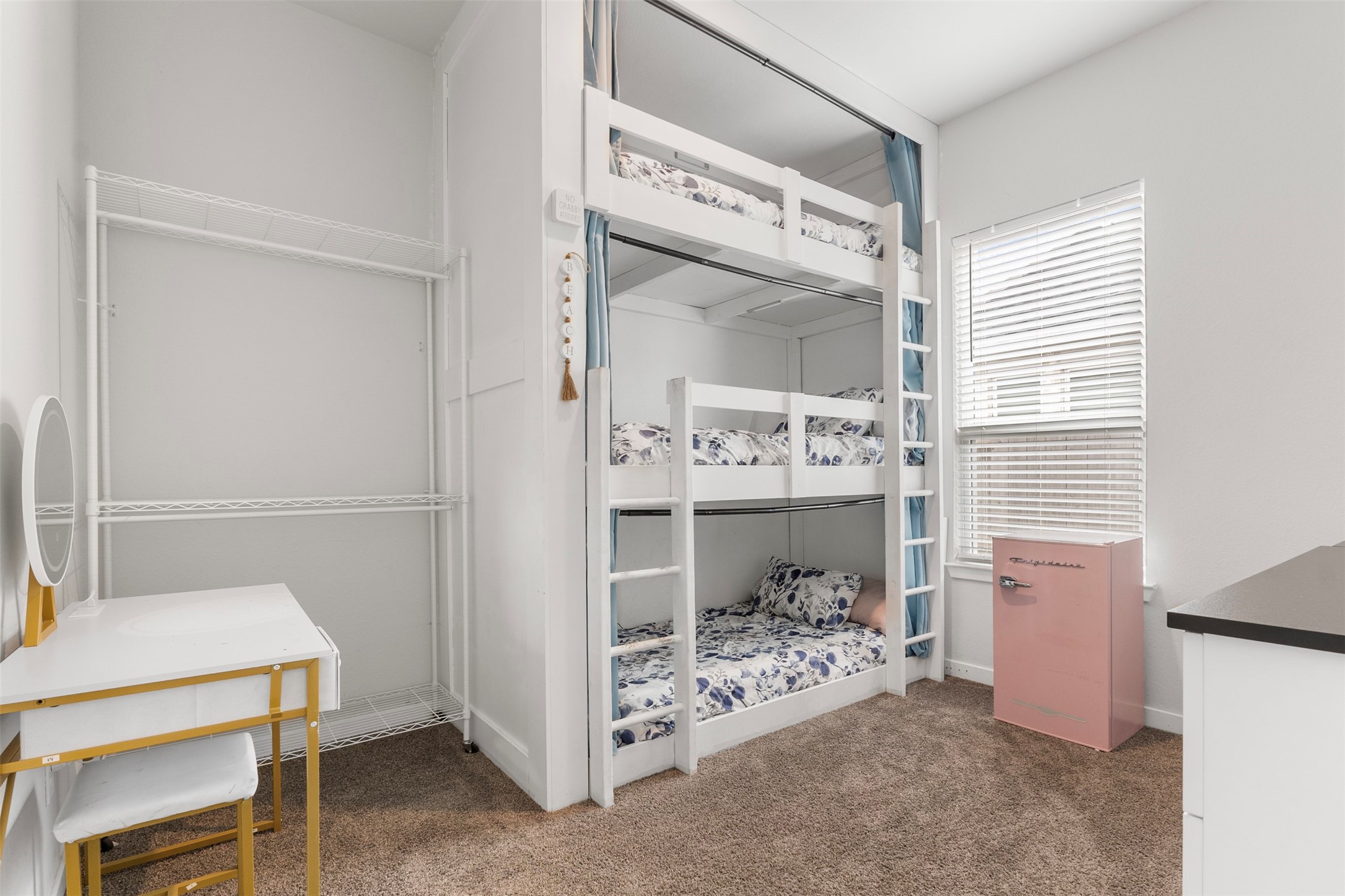 Secondary bedroom with one-of-a-kind built-in triple bunk beds with privacy curtains on every level.