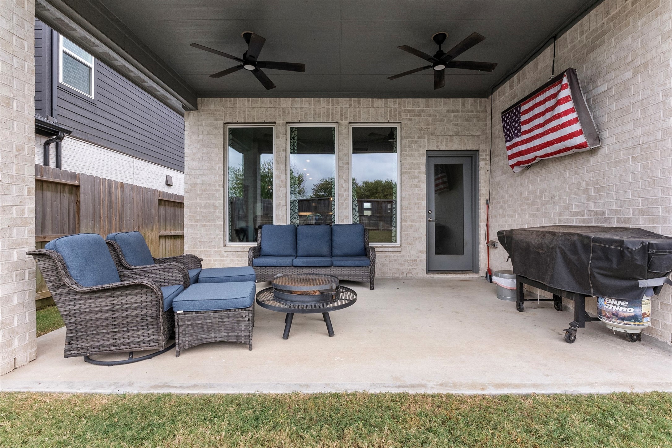 Morning coffee, weekend cookouts and evenings around the fire pit all happen here, on the extended covered patio with ceiling fans to keep things comfortable.