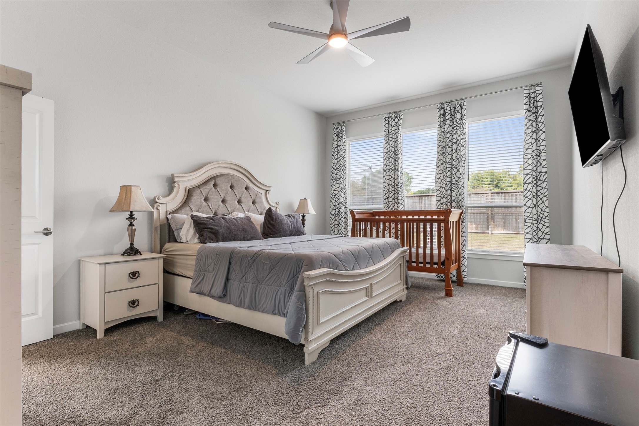 Wake up to natural light and backyard views in the oversized primary suite, a private retreat tucked away from the rest of the home.