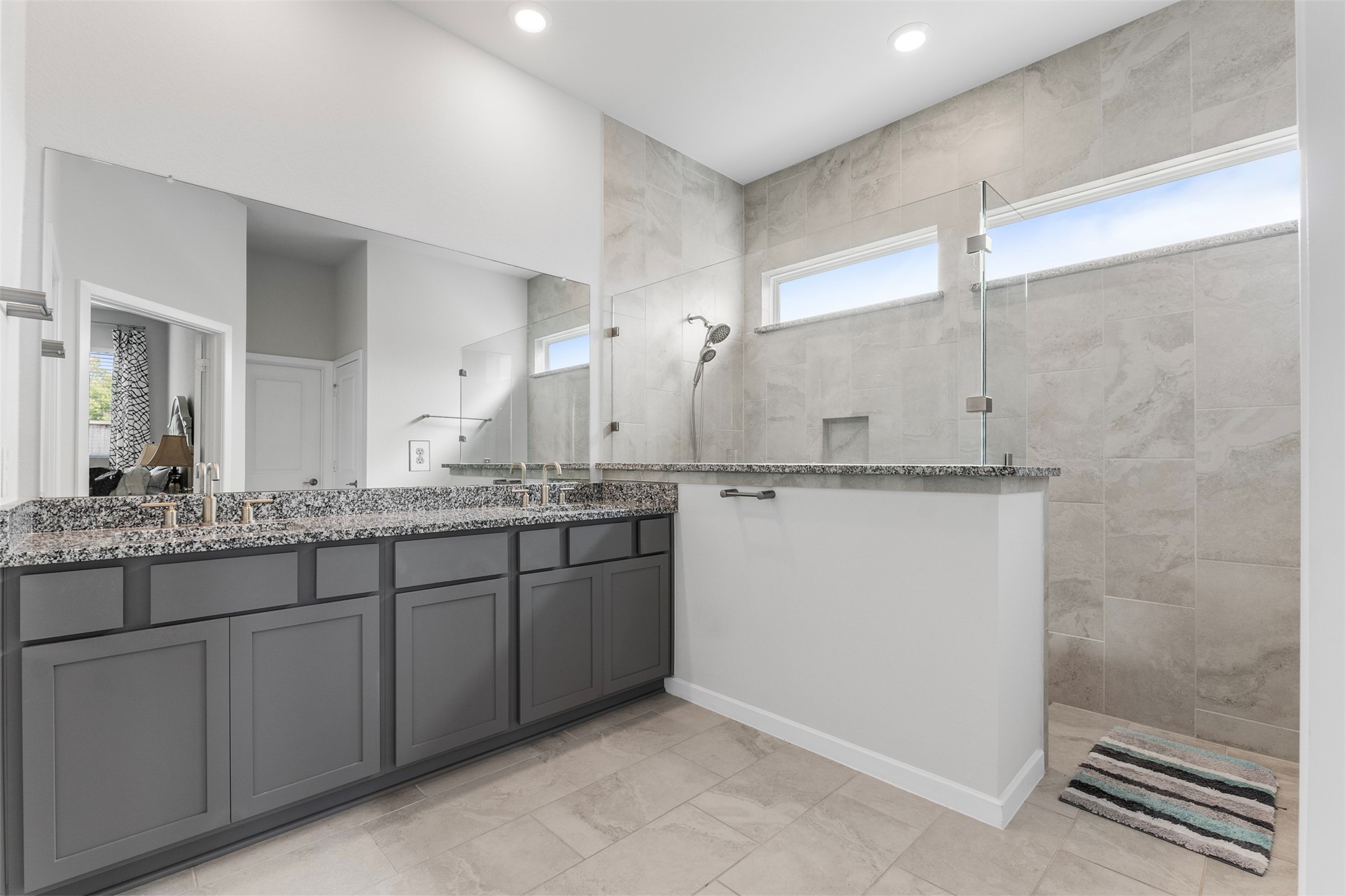 Spa-style primary bath with dual sinks and an oversized walk-in shower.
