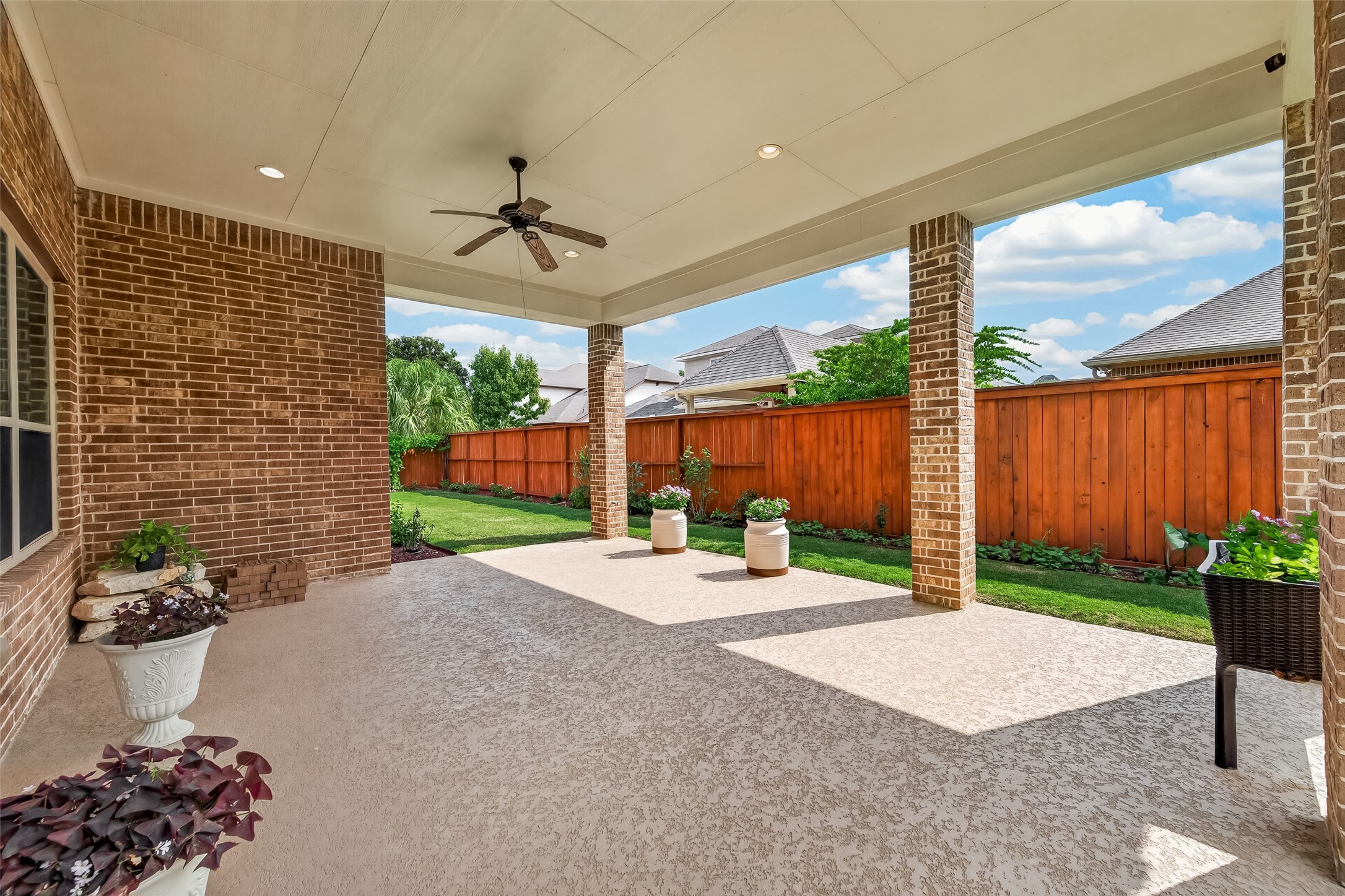 Covered Back Patio with lush landscaping, gas hookup ready for outdoor kitchen