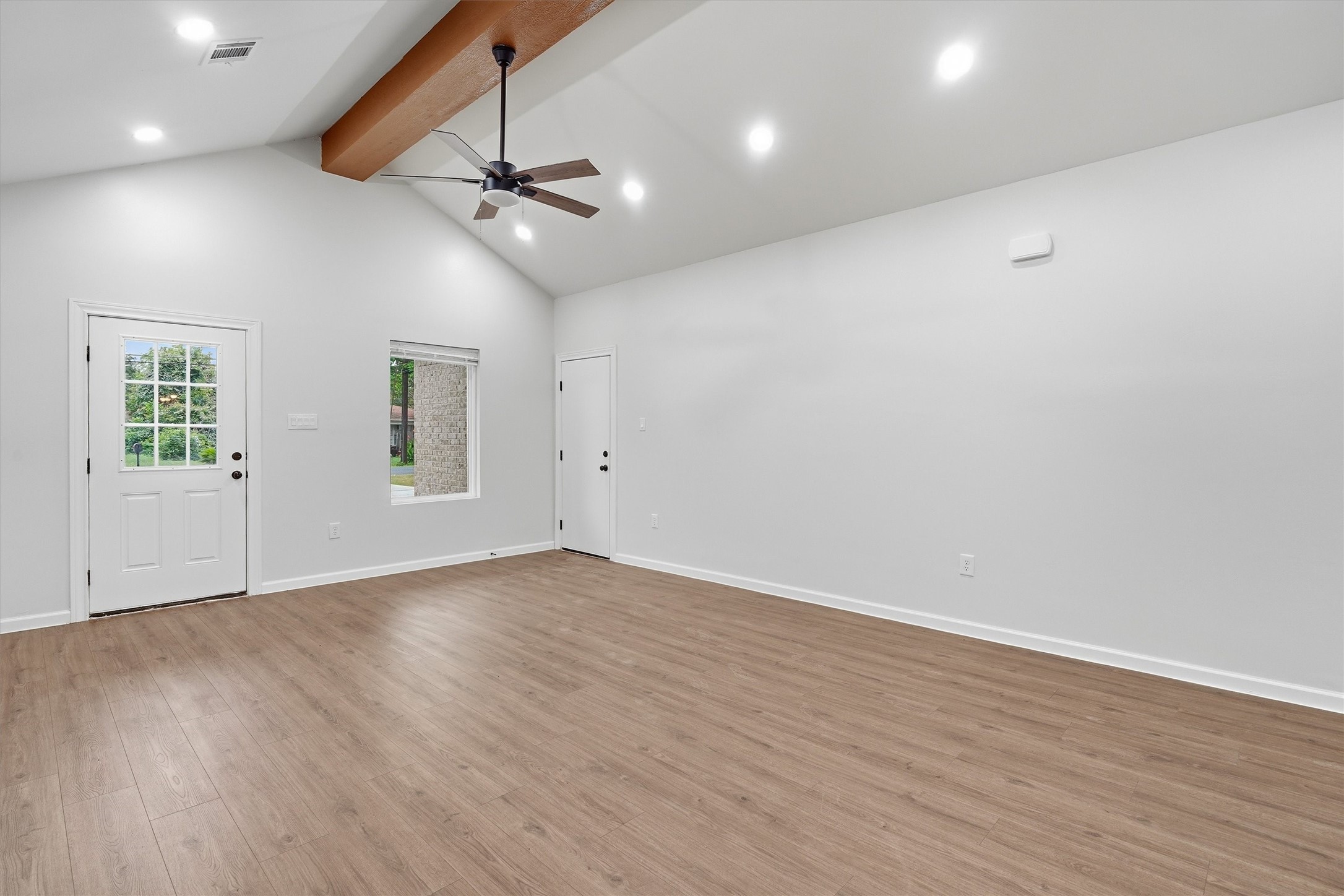 Living room area, exposed beam and updated ceiling fan