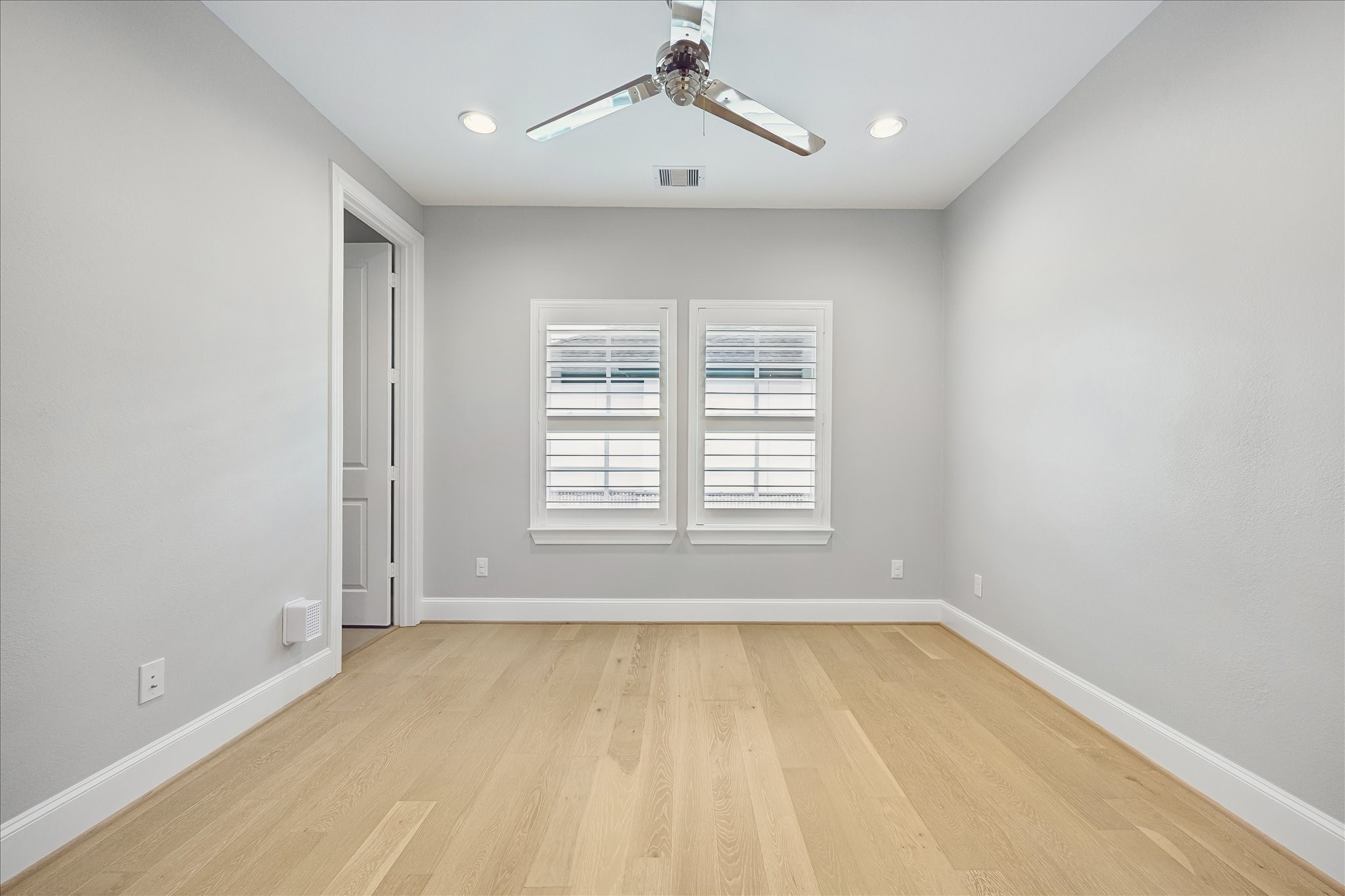 En-suite bath for 3rd floor bedroom. Modern bathroom featuring sleek gray tile, a spacious bathtub with an overhead shower, and a stylish vanity with ample storage.