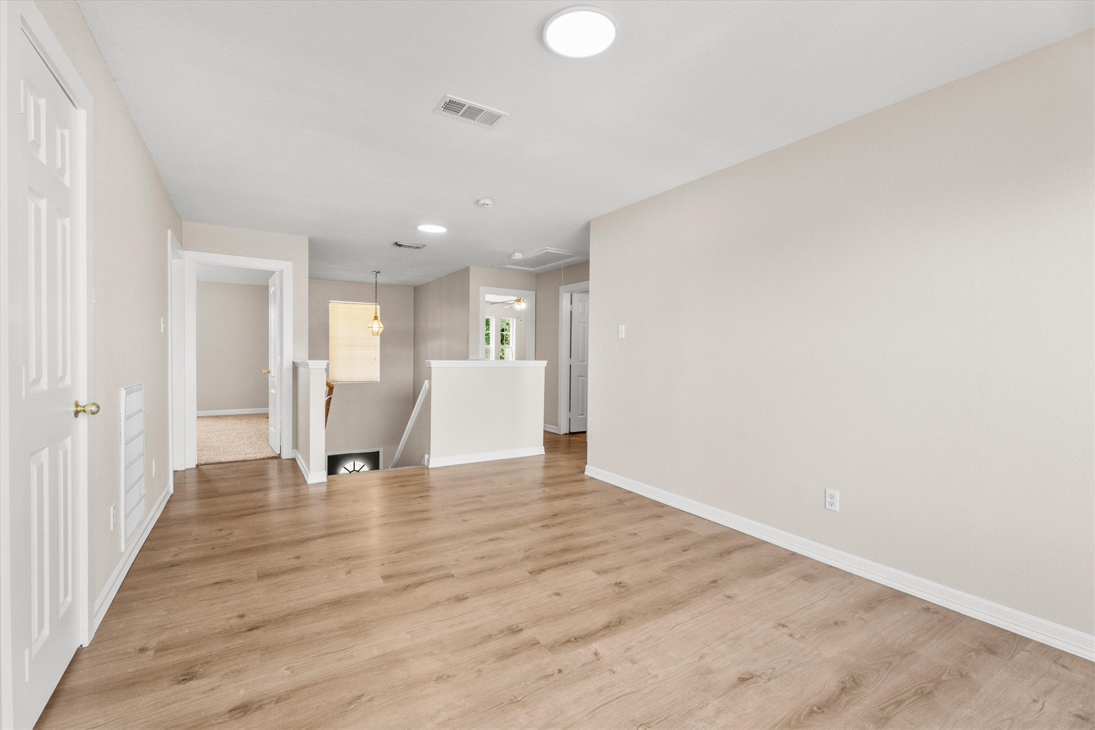 Large upstairs bonus room with easy access to nearby bedrooms and ample room for multiple uses.